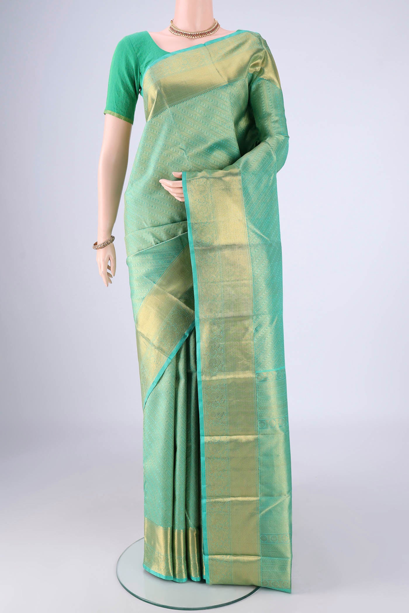 Sea Green Kanjivaram Silk Saree with Zari Brocade on the body and Zari Border.  displayed on a mannequin