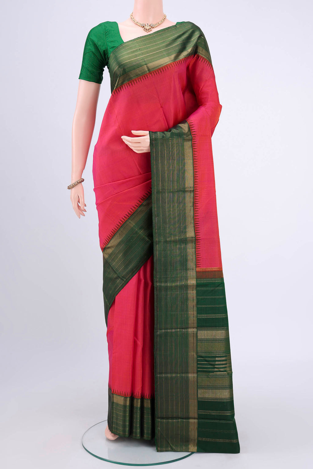 Dark Pink Kanjivaram Silk Saree with Jacquard design on the body and Zari Border.  displayed on a mannequin