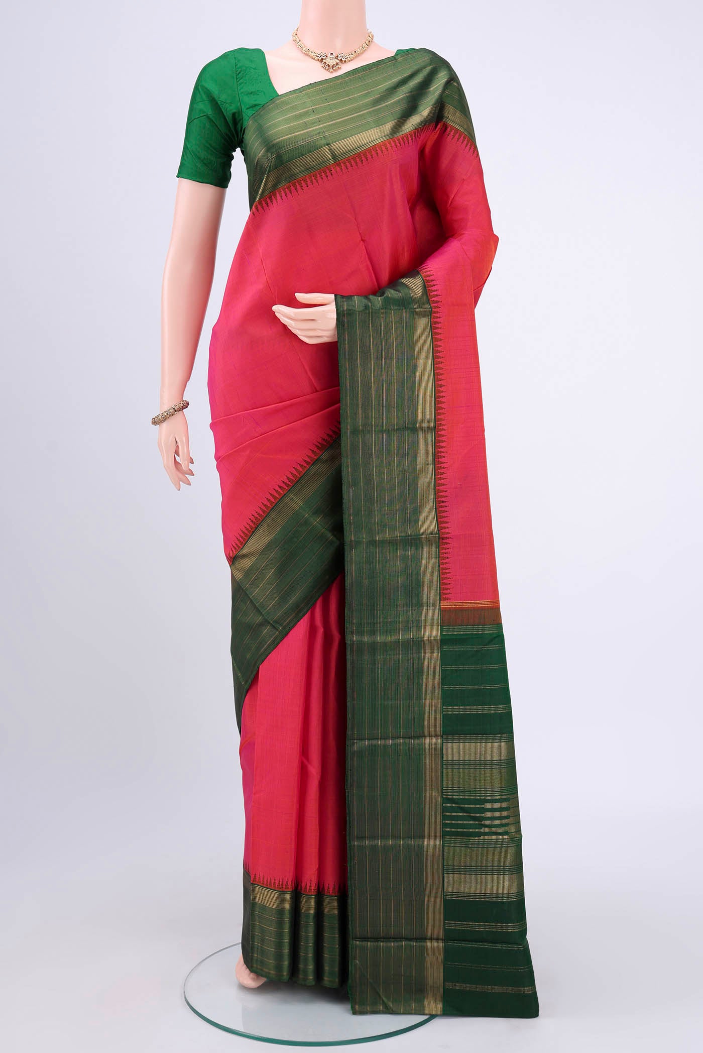 Dark Pink Kanjivaram Silk Saree with Jacquard design on the body and Zari Border.  displayed on a mannequin