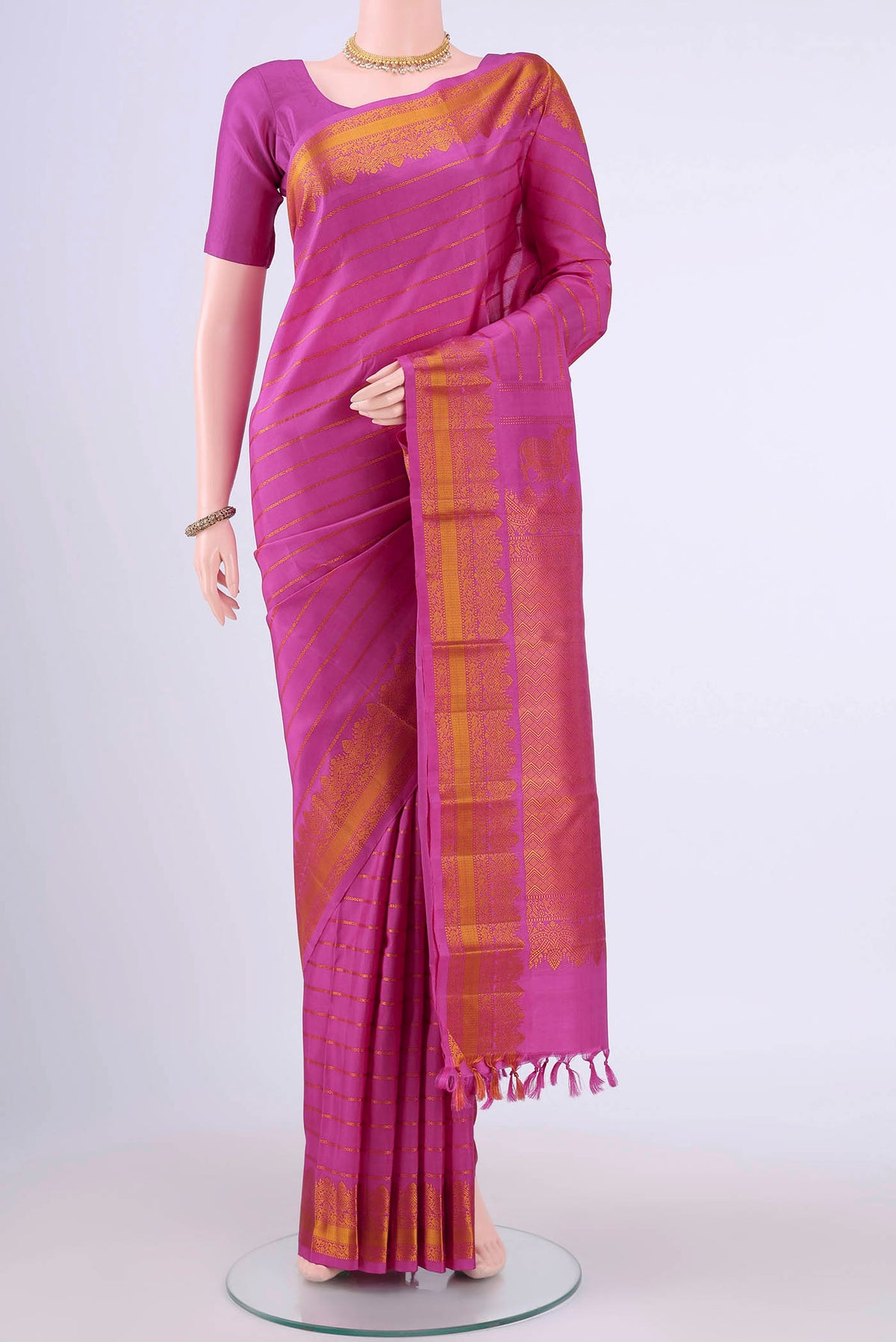 Rani Pink Kanchipuram Silk Saree with Stripes on the body and Thread Border displayed on a mannequin