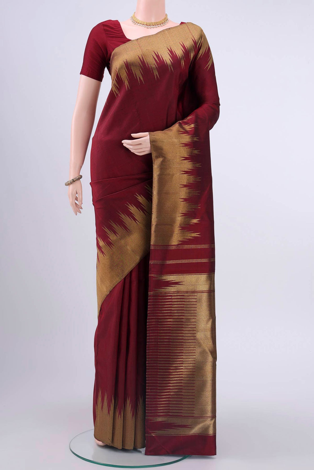 Pure Silk Pure Zari Maroon Kanchipuram Saree with Plain Body and Temple Border displayed on a mannequin