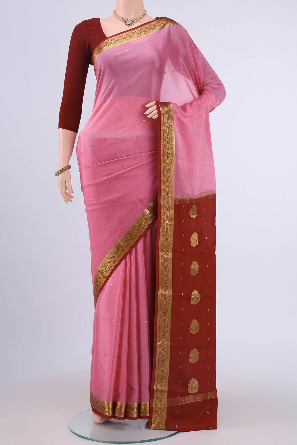 Rose pink Mysore Crepe Saree with Zari Butta on the body and Zari Border displayed on a mannequin