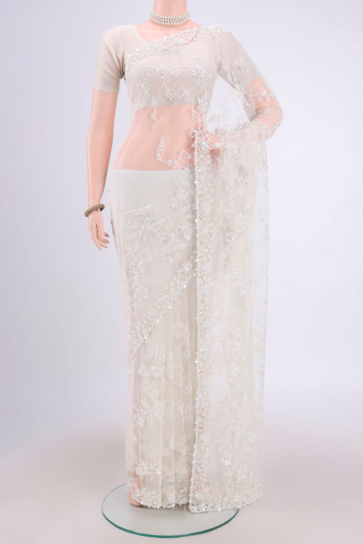 White Organza Silk Saree with Embroidery on the body and Embroidery Border.  displayed on a mannequin