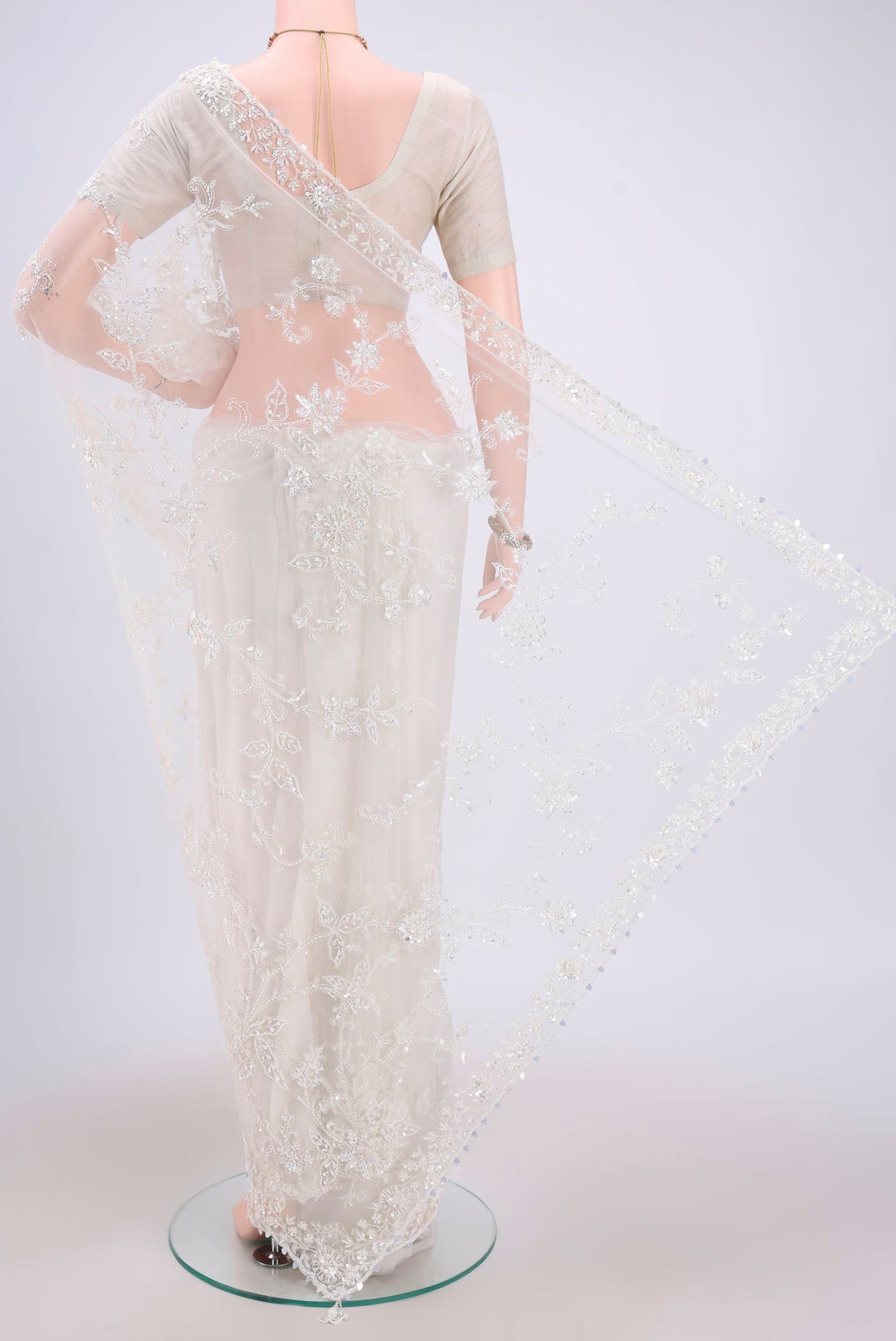 Flat view of White Organza Silk Saree with Embroidery on the body and Embroidery Border. 