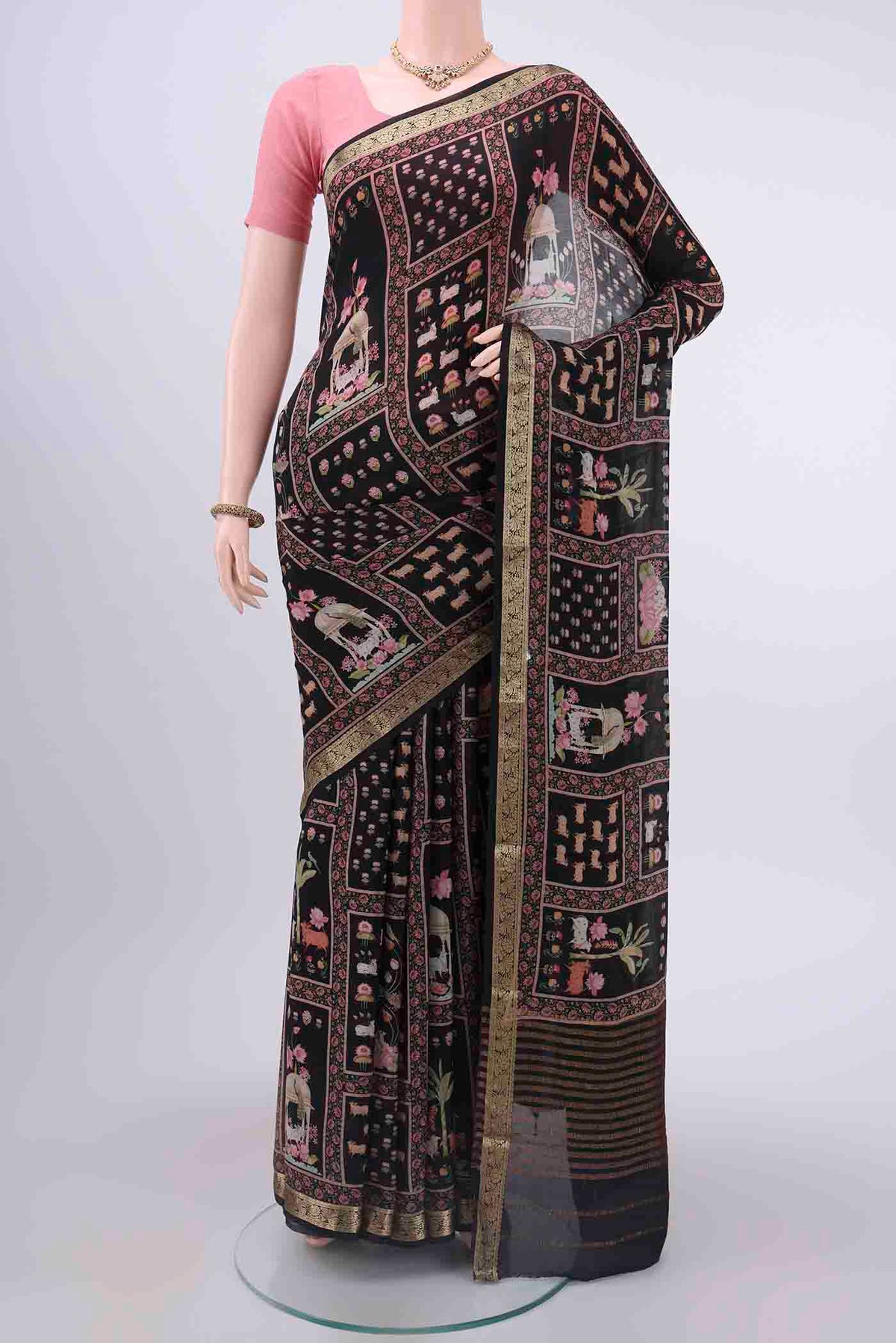 Black Mysore Crepe Saree with Printed design on the body and Zari Border displayed on a mannequin
