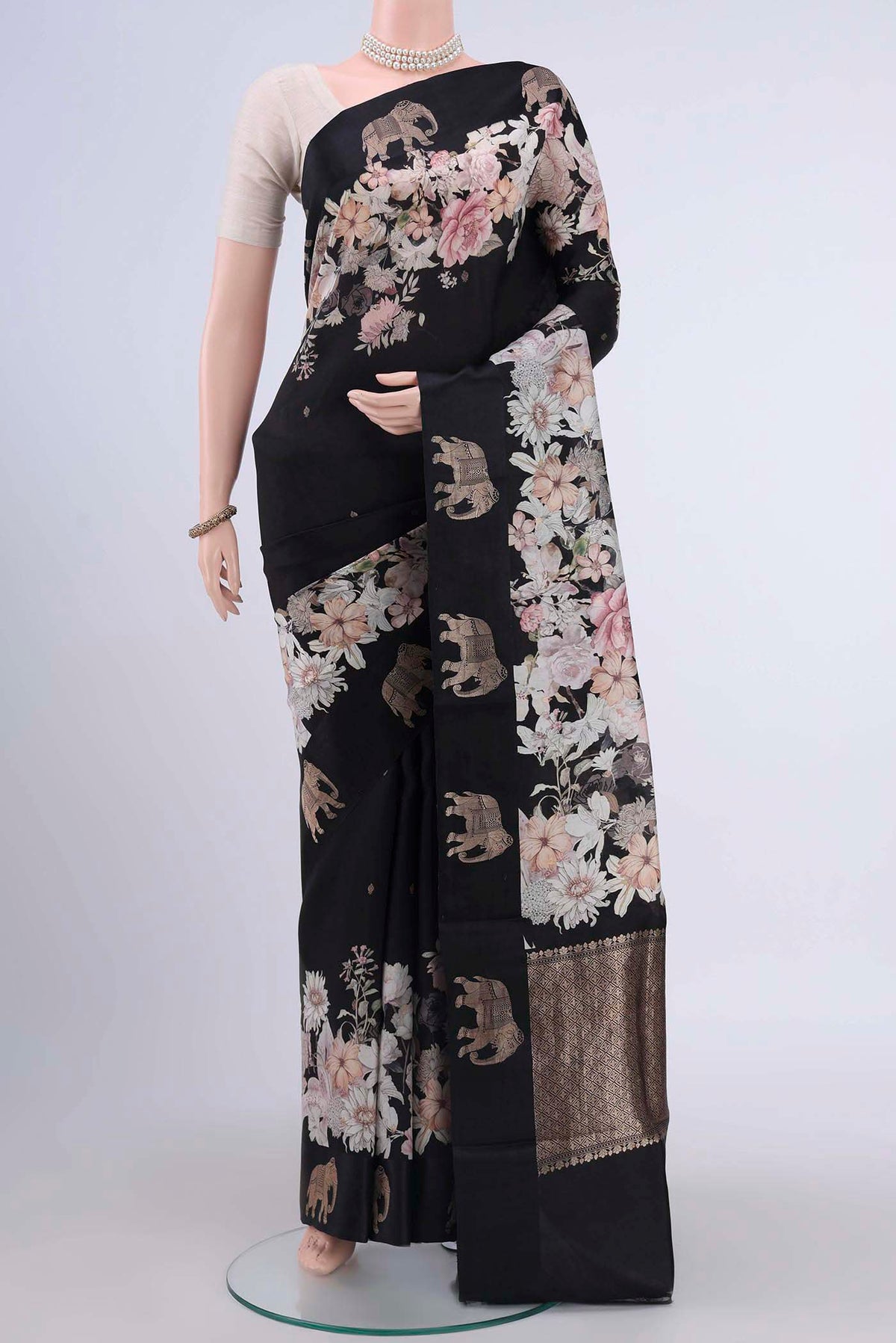 Black Printed Silk Saree with Floral Print on the body and Satin Border displayed on a mannequin