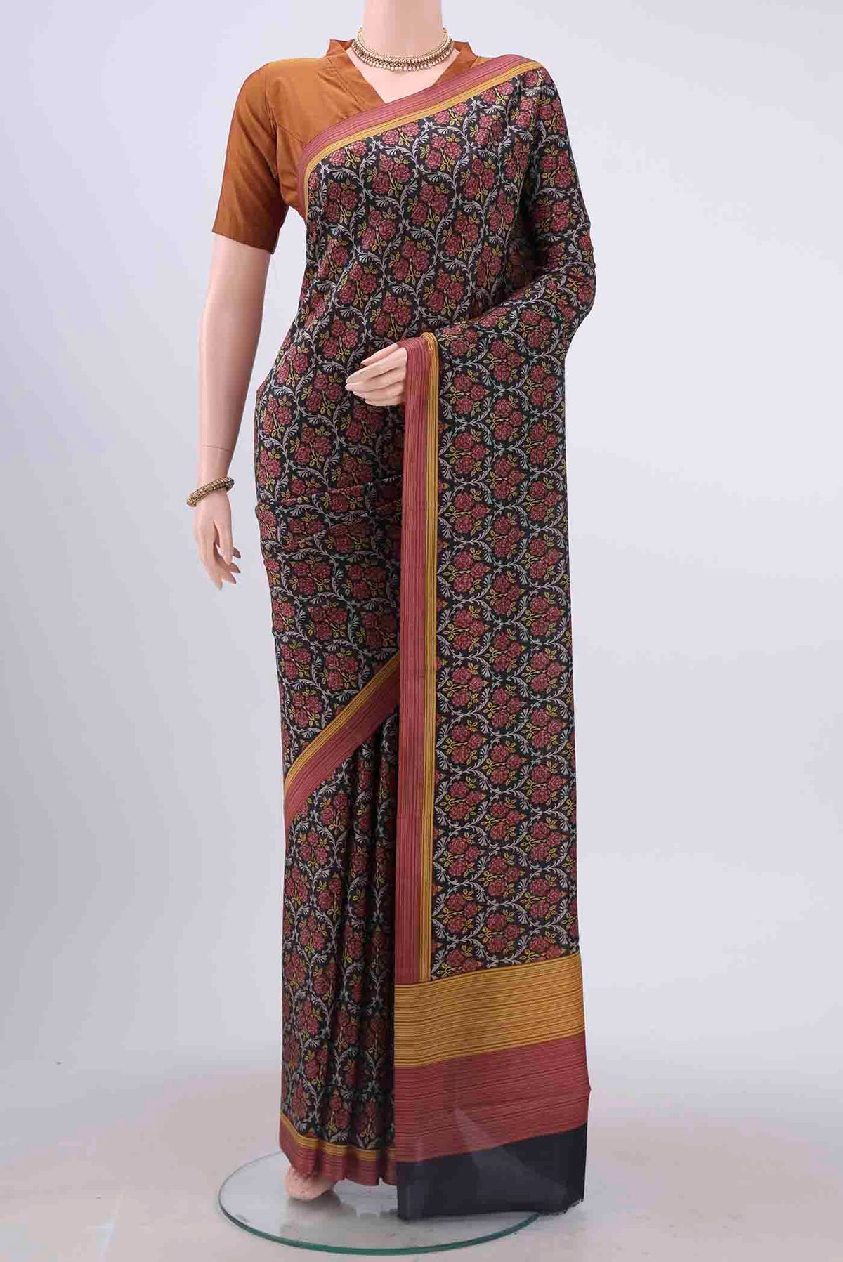 Black Printed Silk Saree with Printed design on the body and Plain Border displayed on a mannequin