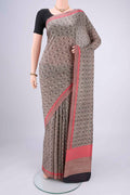 Off White Printed Silk Saree with Floral Print on the body and Printed Border.  displayed on a mannequin