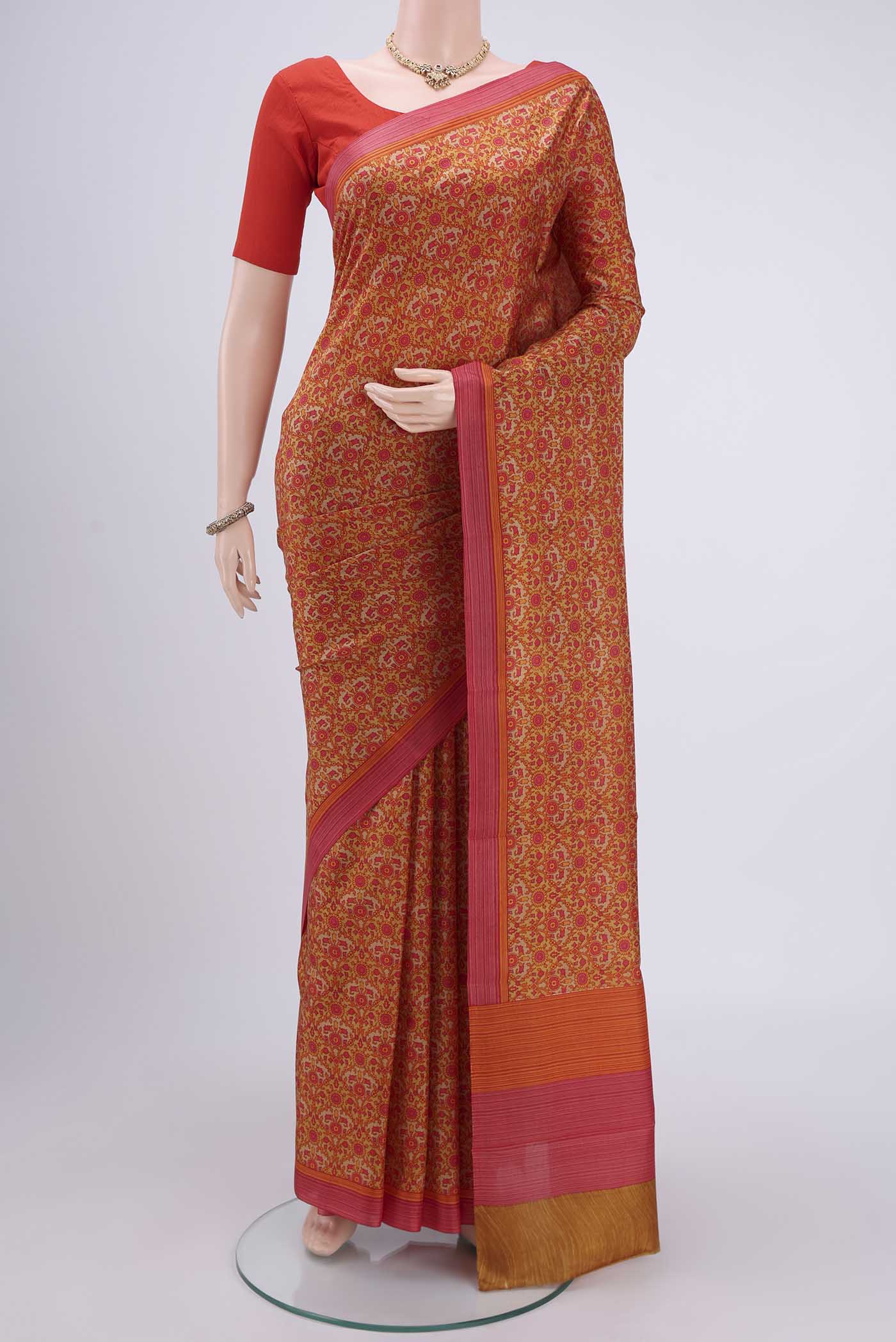 Mustard Printed Silk Saree with Printed design on the body and Plain Border.  displayed on a mannequin