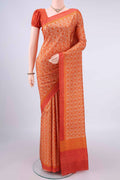 Pure Silk Orange Printed Saree with Printed design on the body and Plain Border.  displayed on a mannequin