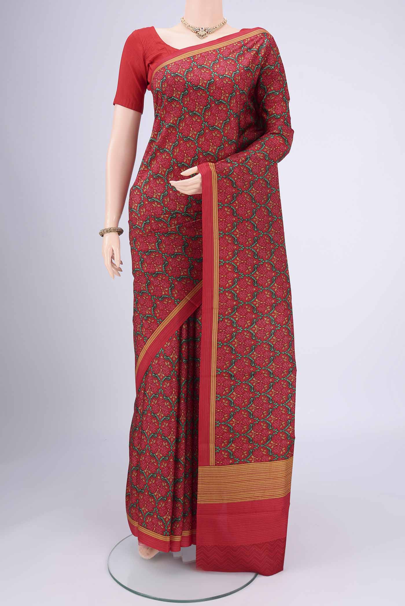 Red Printed Silk Saree with Floral Print on the body and Printed Border.  displayed on a mannequin