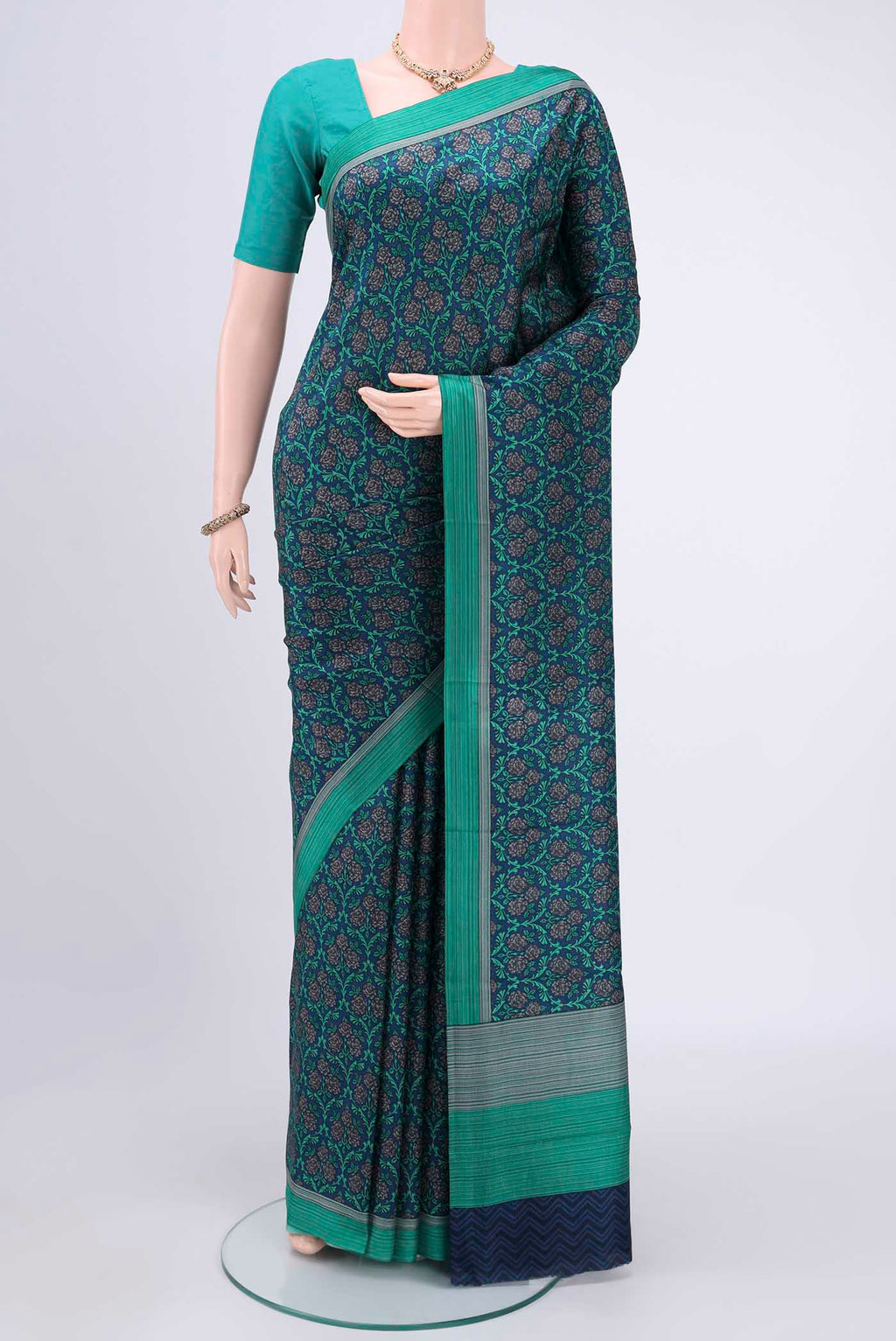 Navy Blue Printed Silk Saree with Printed design on the body and Plain Border.  displayed on a mannequin
