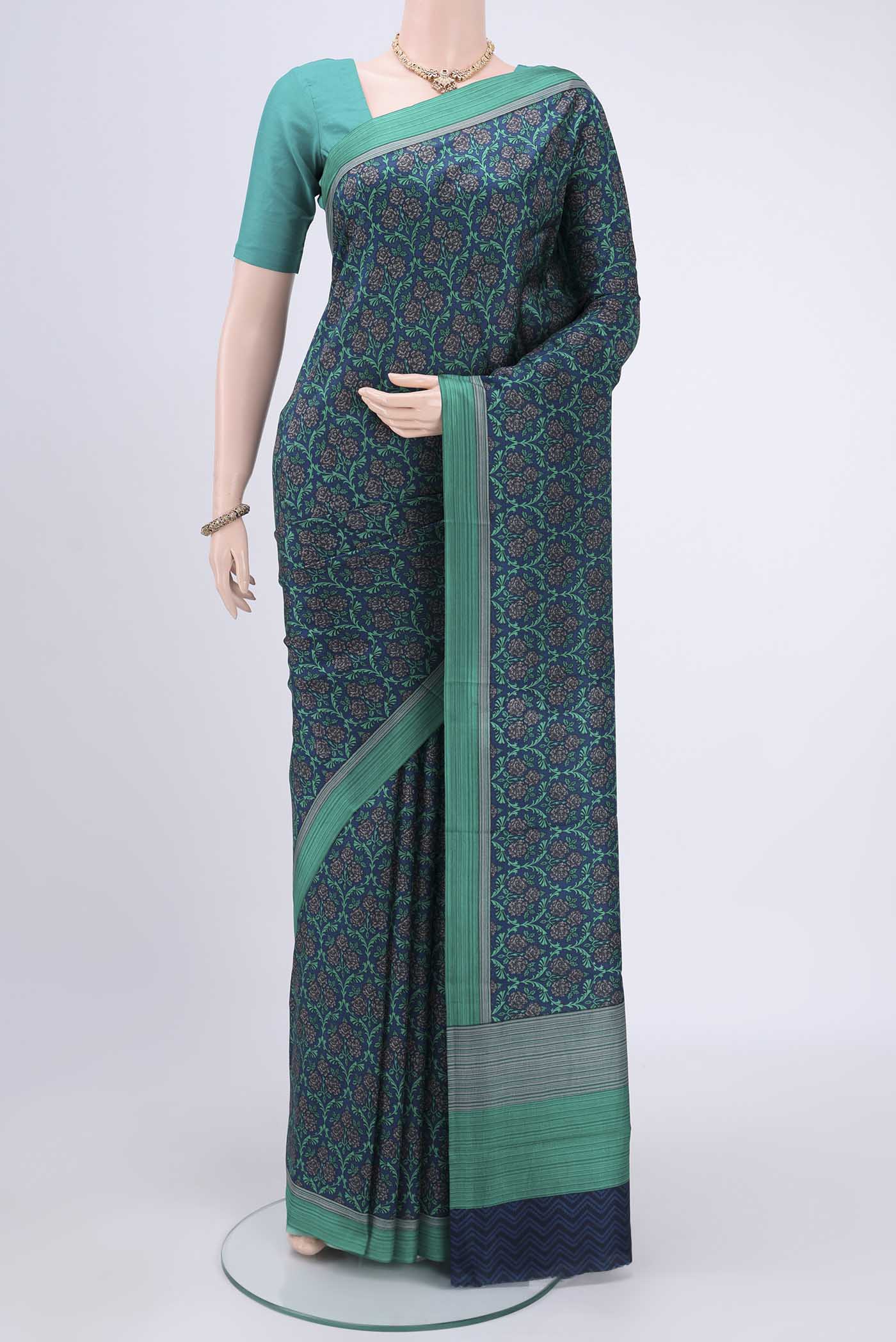 Navy Blue Printed Silk Saree with Printed design on the body and Plain Border.  displayed on a mannequin