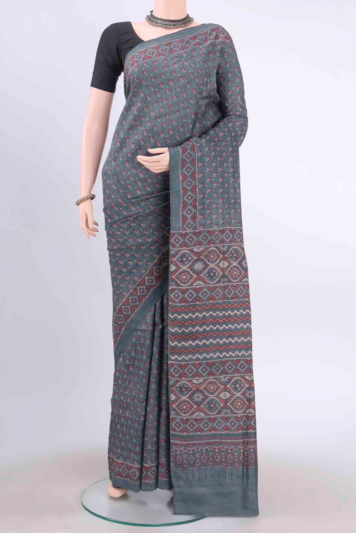 Blue Grey Tussar Silk Saree with Ajrakh Print on the body and Printed Border displayed on a mannequin