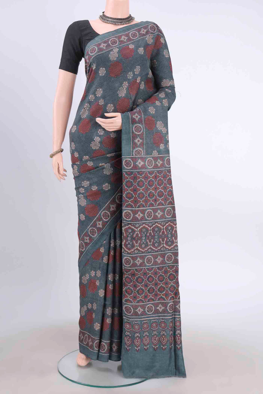 Blue Grey Tussar Silk Saree with Ajrakh Print on the body and Printed Border displayed on a mannequin