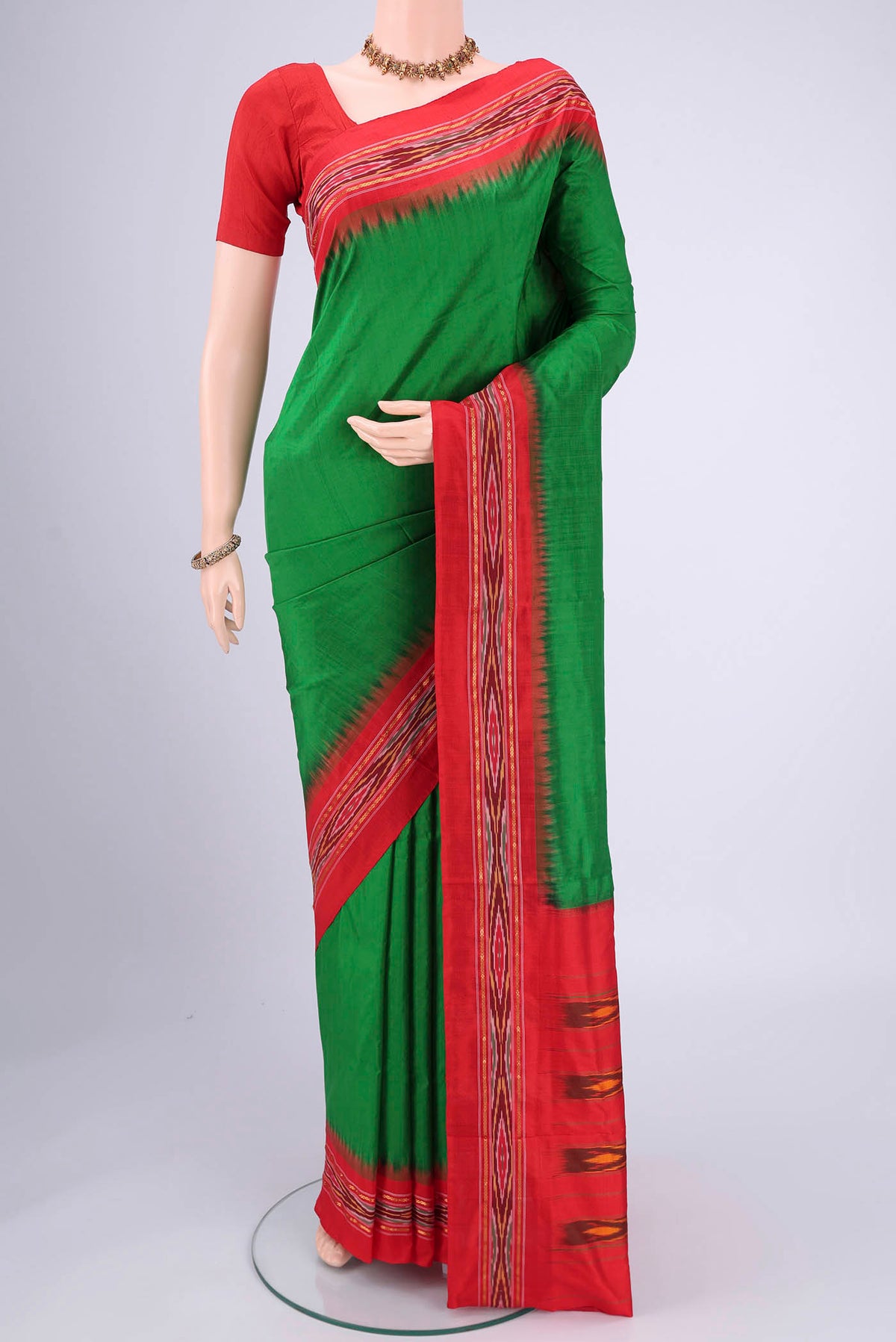 Green Pochampally Silk Saree with Plain Body and Ikat Border.  displayed on a mannequin