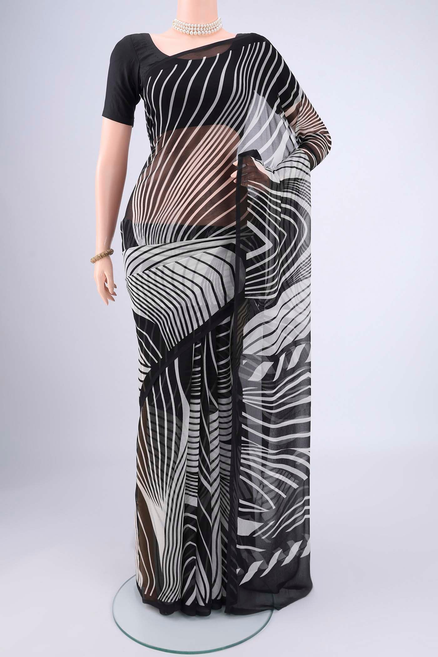 Black Mysore Chiffon Saree with Zig Zag design on the body and Plain Border.  displayed on a mannequin