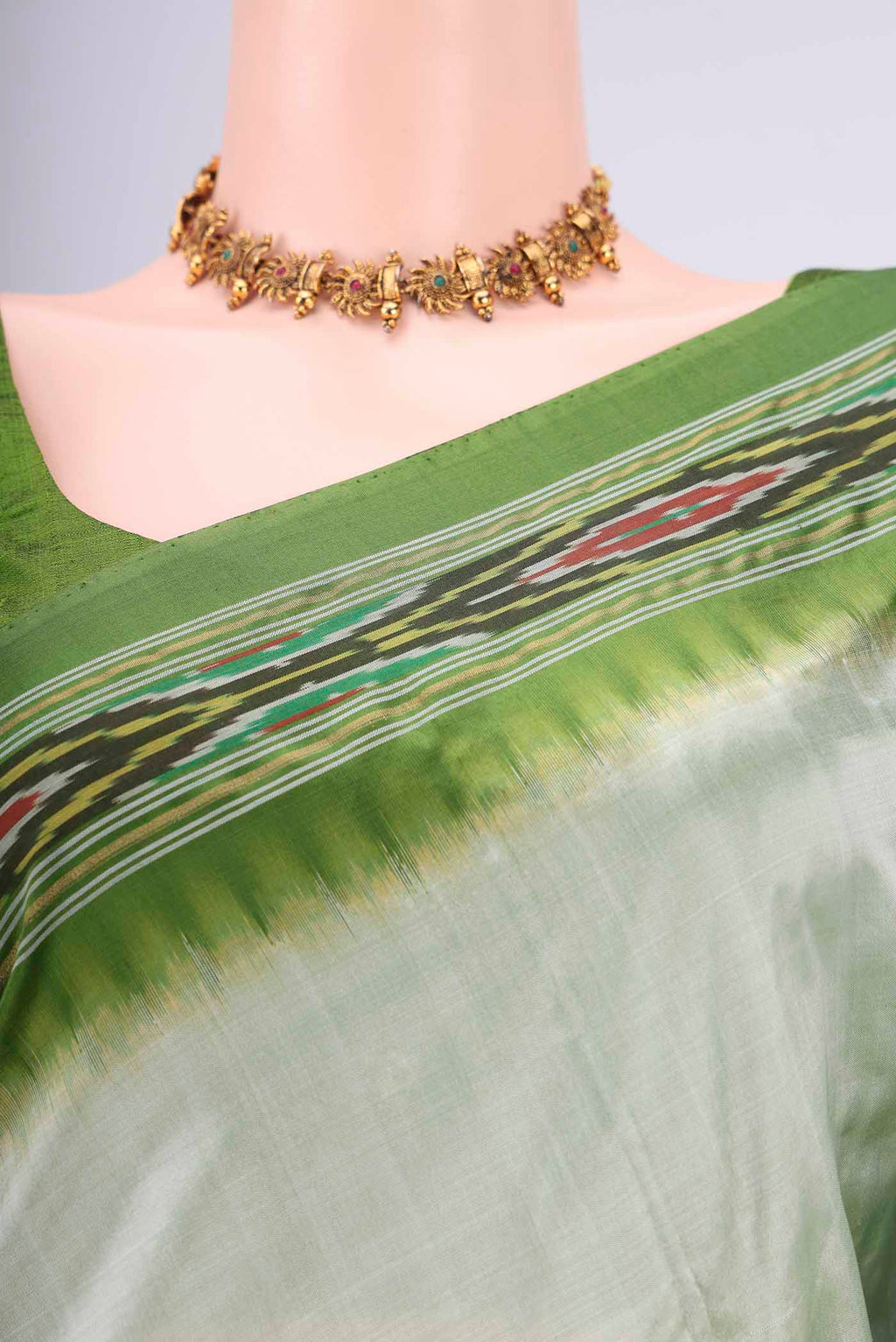 Border image of Mint Green Pochampally Silk Saree with Plain Body and Ikat Border. 