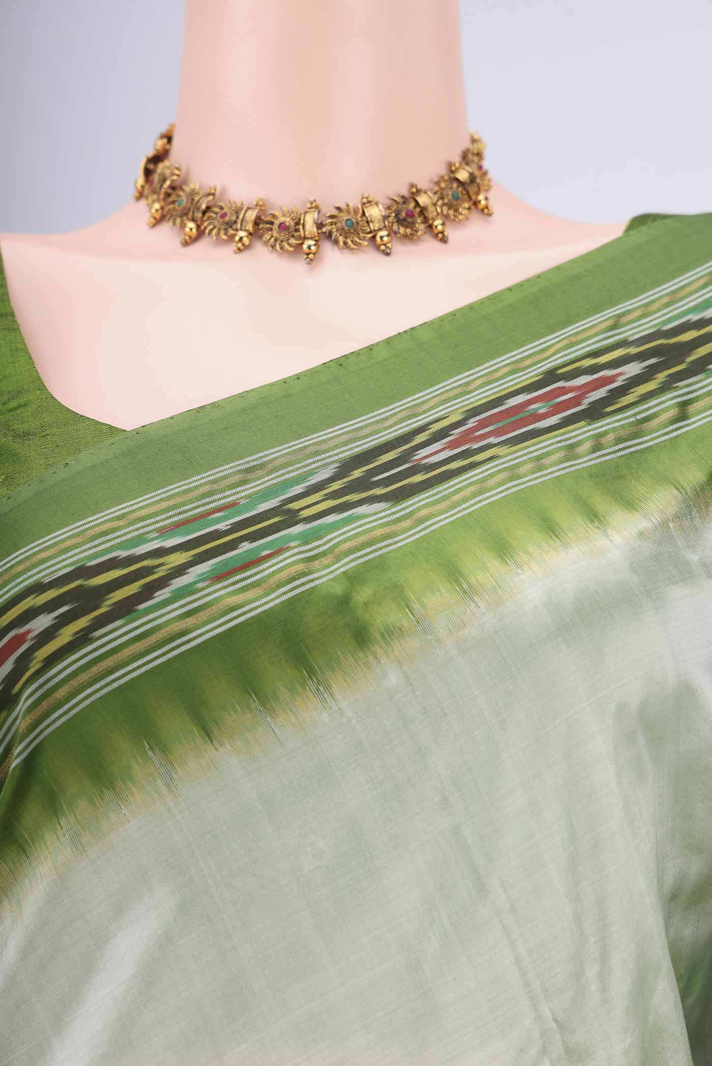 Border image of Mint Green Pochampally Silk Saree with Plain Body and Ikat Border. 