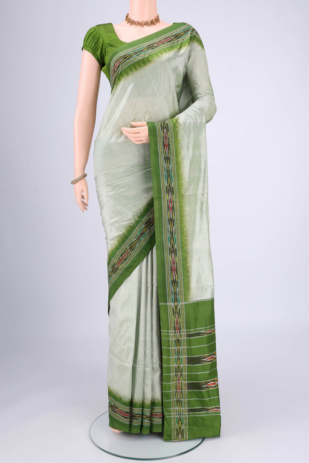 Mint Green Pochampally Silk Saree with Plain Body and Ikat Border.  displayed on a mannequin
