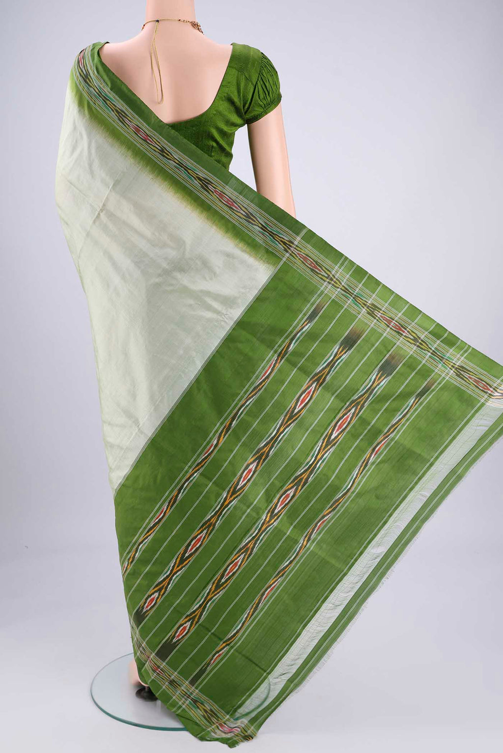 Flat view of Mint Green Pochampally Silk Saree with Plain Body and Ikat Border. 