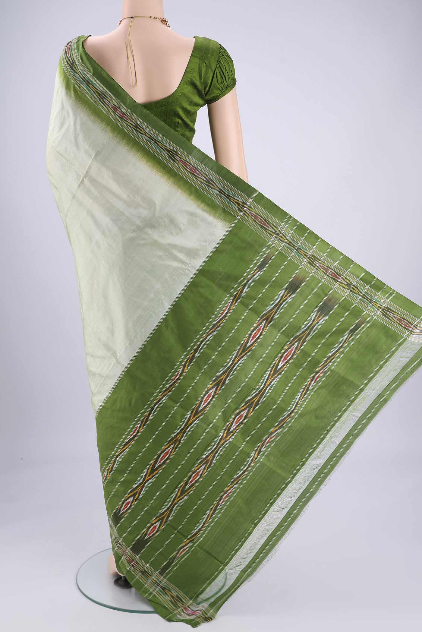 Flat view of Mint Green Pochampally Silk Saree with Plain Body and Ikat Border. 
