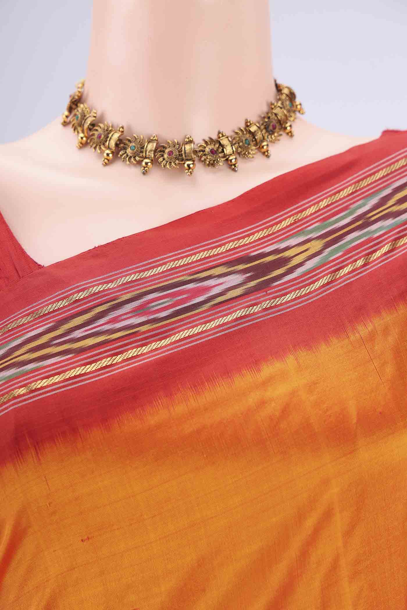 Border image of Orange Pochampally Silk Saree with Plain Body and Ikat Border. 