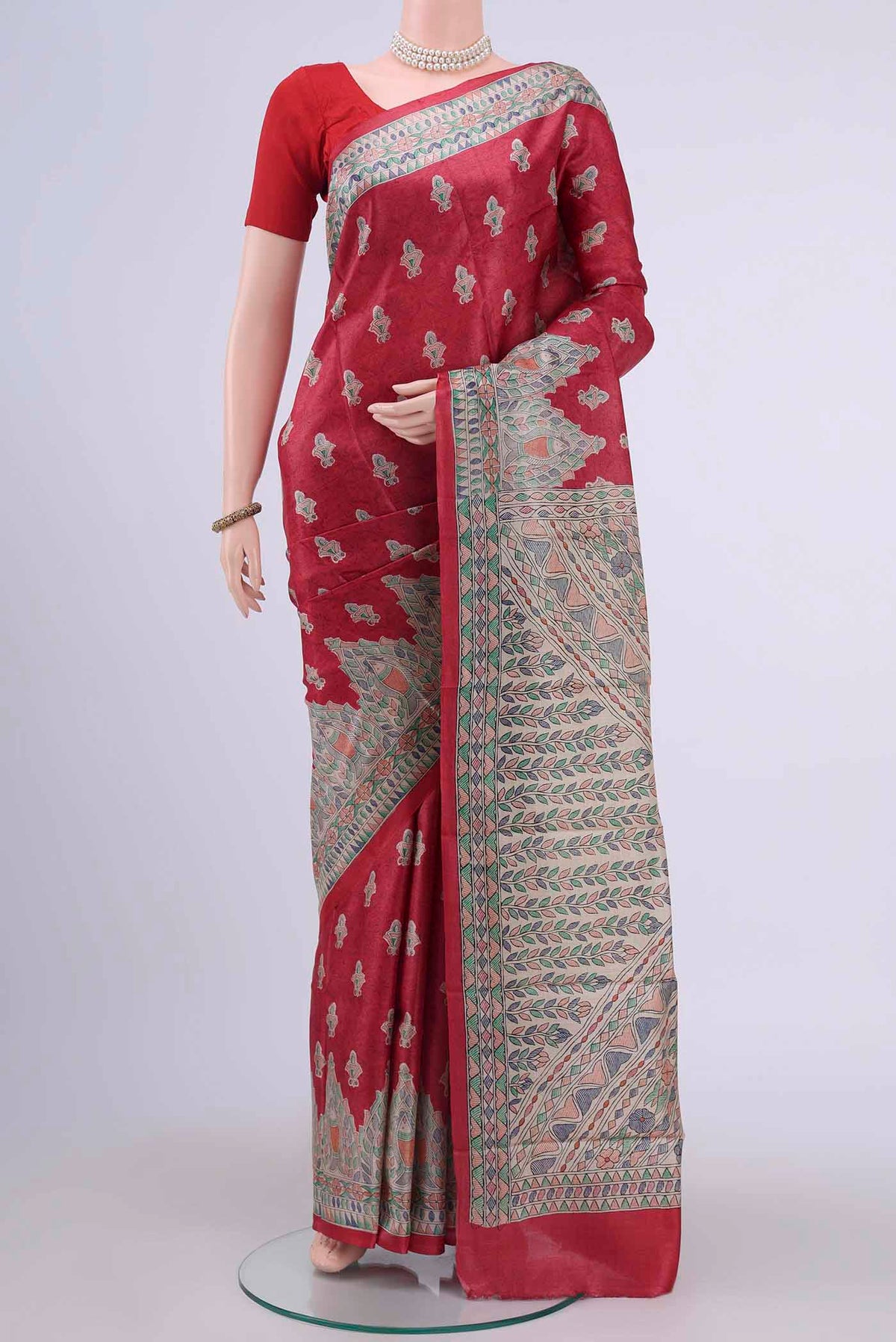 Red Tussar Silk Saree with Printed design on the body and Printed Border displayed on a mannequin