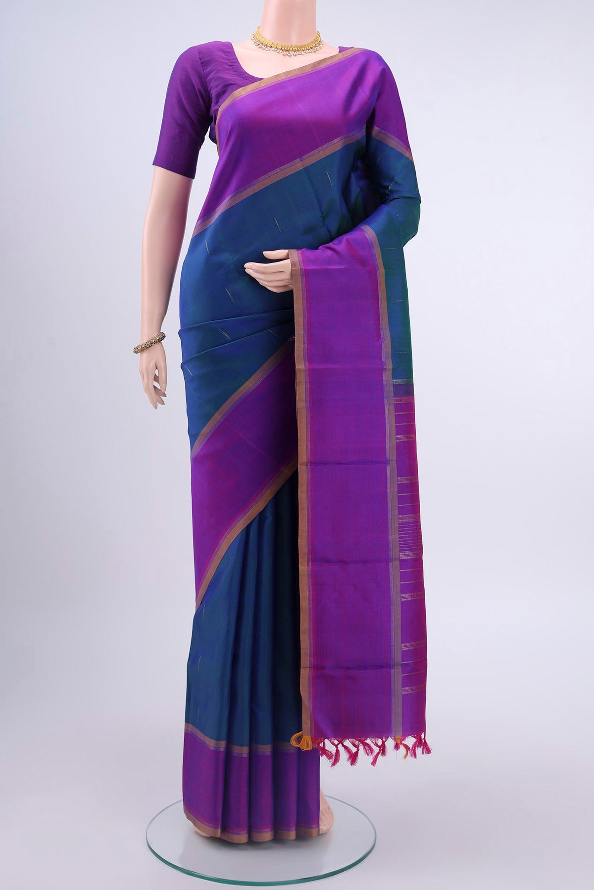 Pure Silk Pure Zari Peacock Blue Kanchipuram Saree with Zari Butta on the body and Plain Border displayed on a mannequin