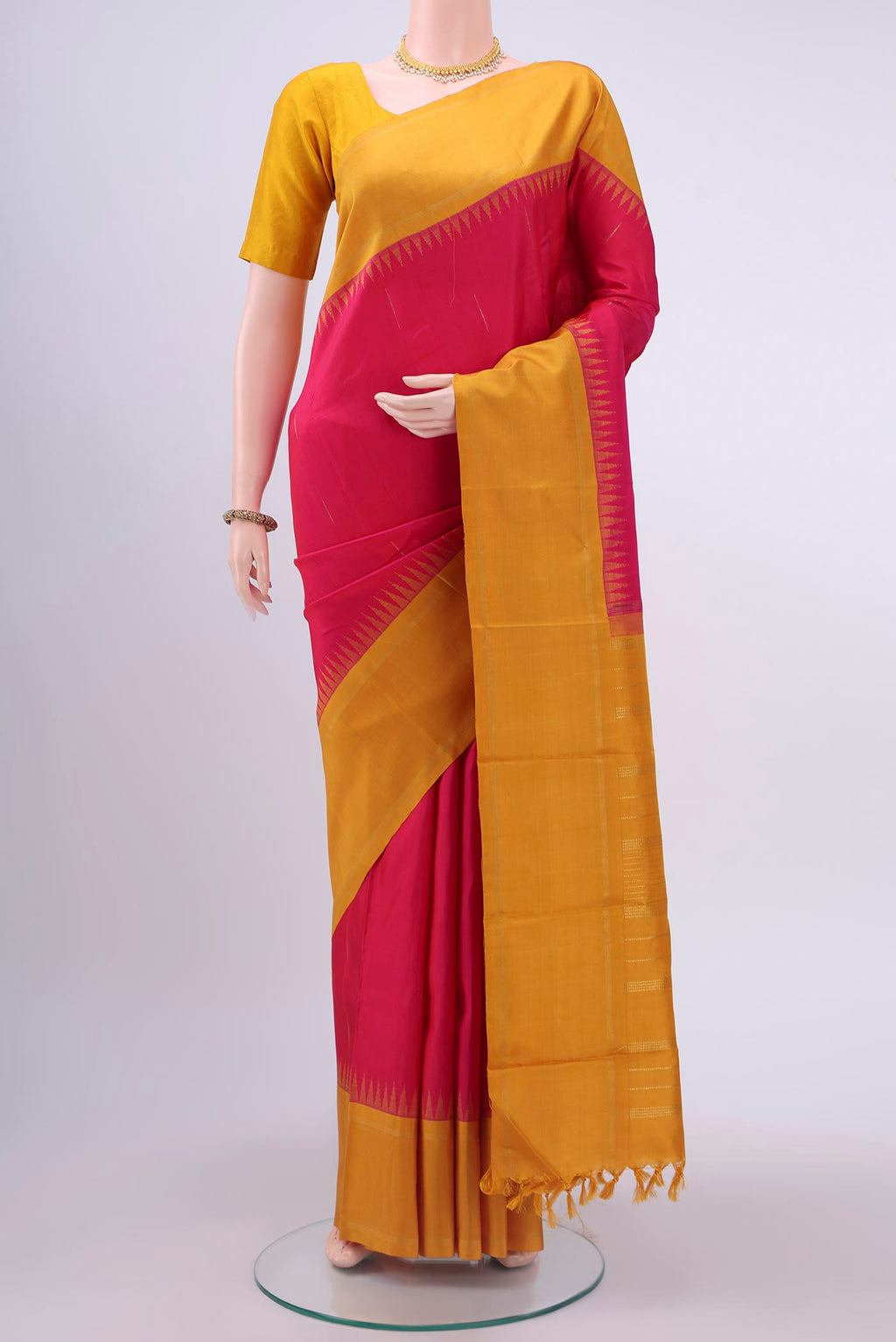 Pure Silk Pure Zari Pink Kanchipuram Saree with Stripes on the body and Temple Border displayed on a mannequin