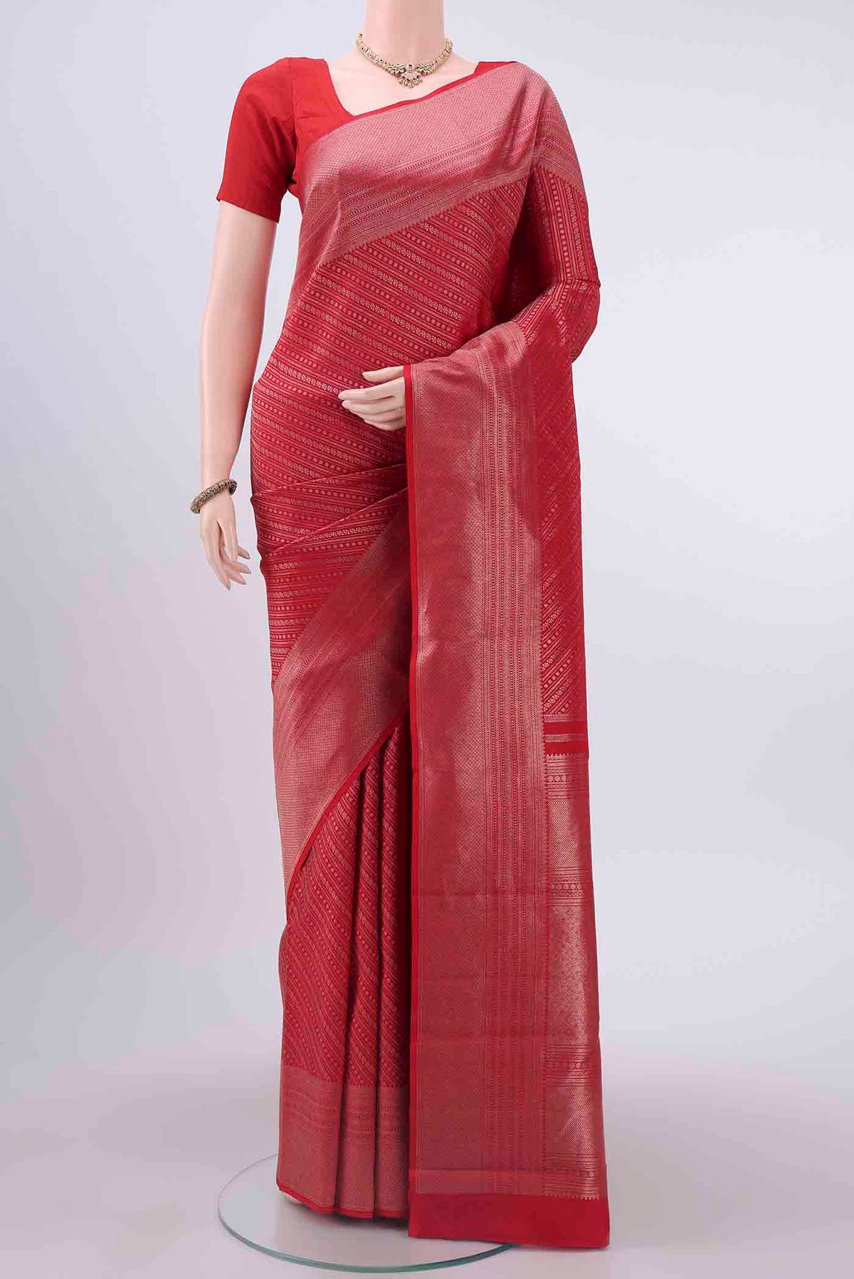Red Kanchipuram Silk Saree with Zari Brocade on the body and Zari Border displayed on a mannequin