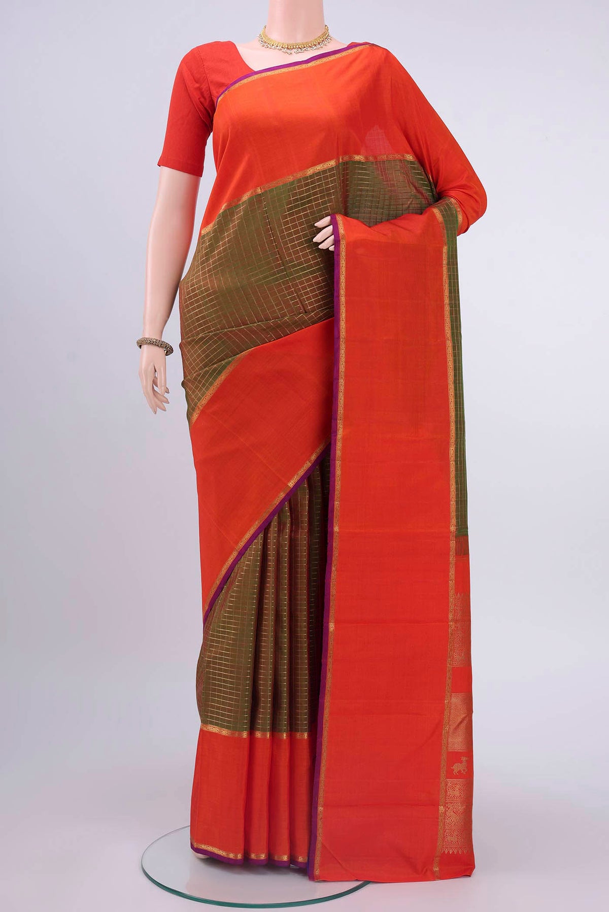 Pure Silk Pure Zari Green Kanchipuram Saree with Checked design on the body and Zari Border displayed on a mannequin