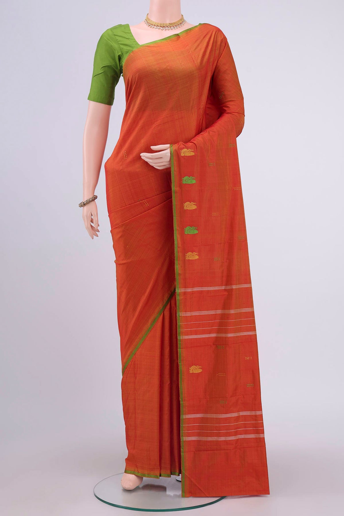 Brick Orange Kanchipuram Silk Saree with Thread Butta on the body and Thread Border displayed on a mannequin
