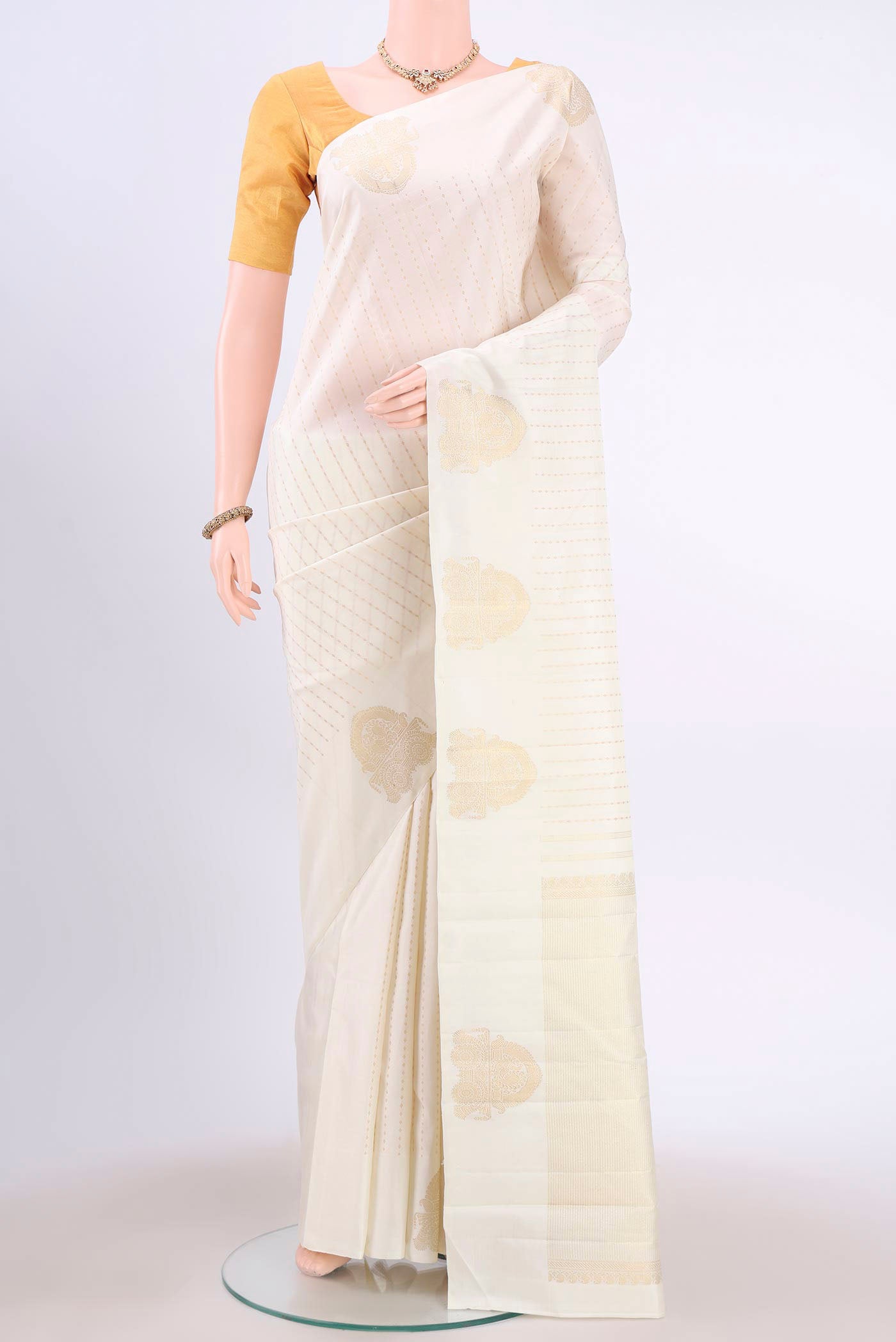 Pure Silk Pure Zari Off White Kanchipuram Saree with Zari Butta on the body and Zari Border displayed on a mannequin