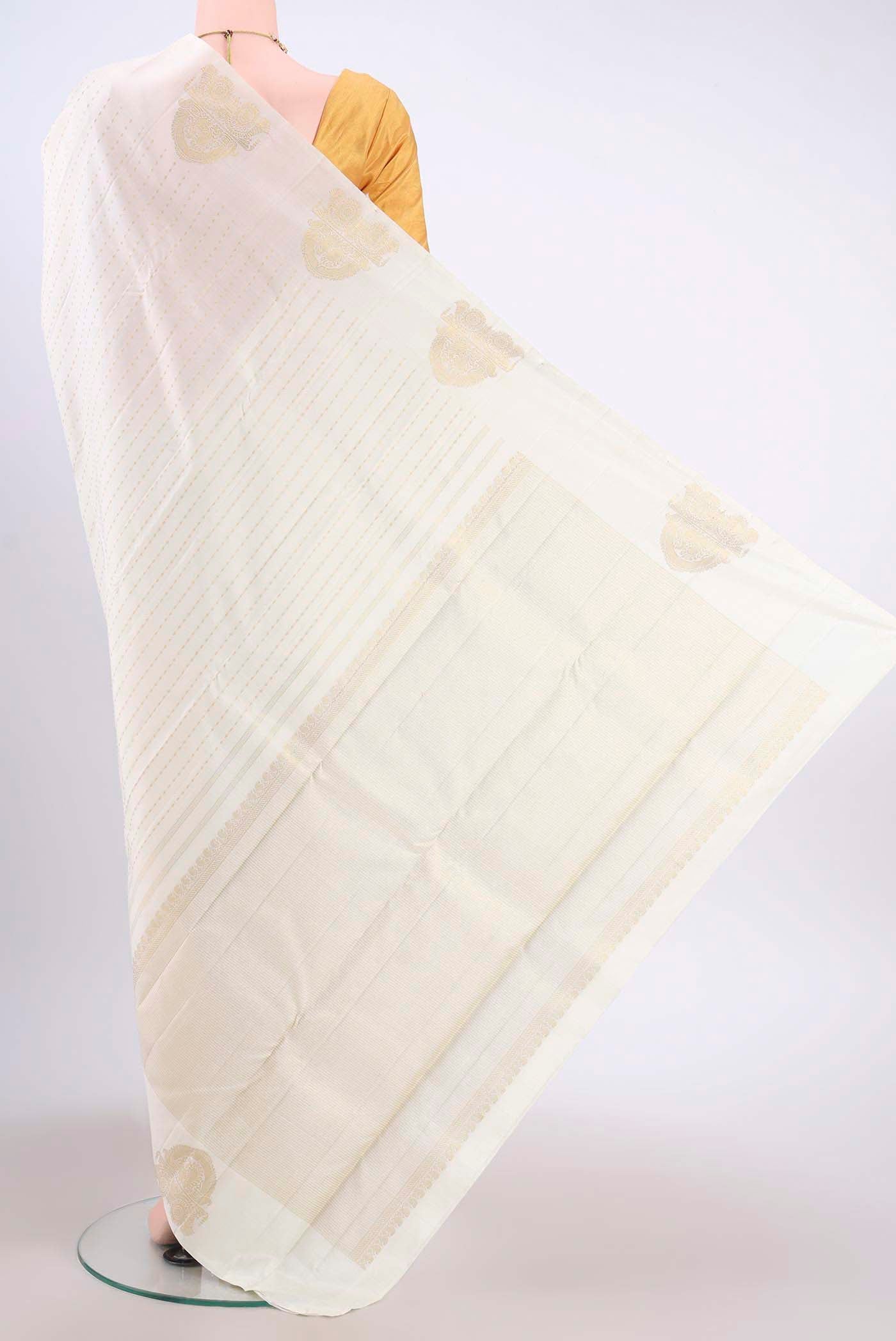 Flat view of Pure Silk Pure Zari Off White Kanchipuram Saree with Zari Butta on the body and Zari Border