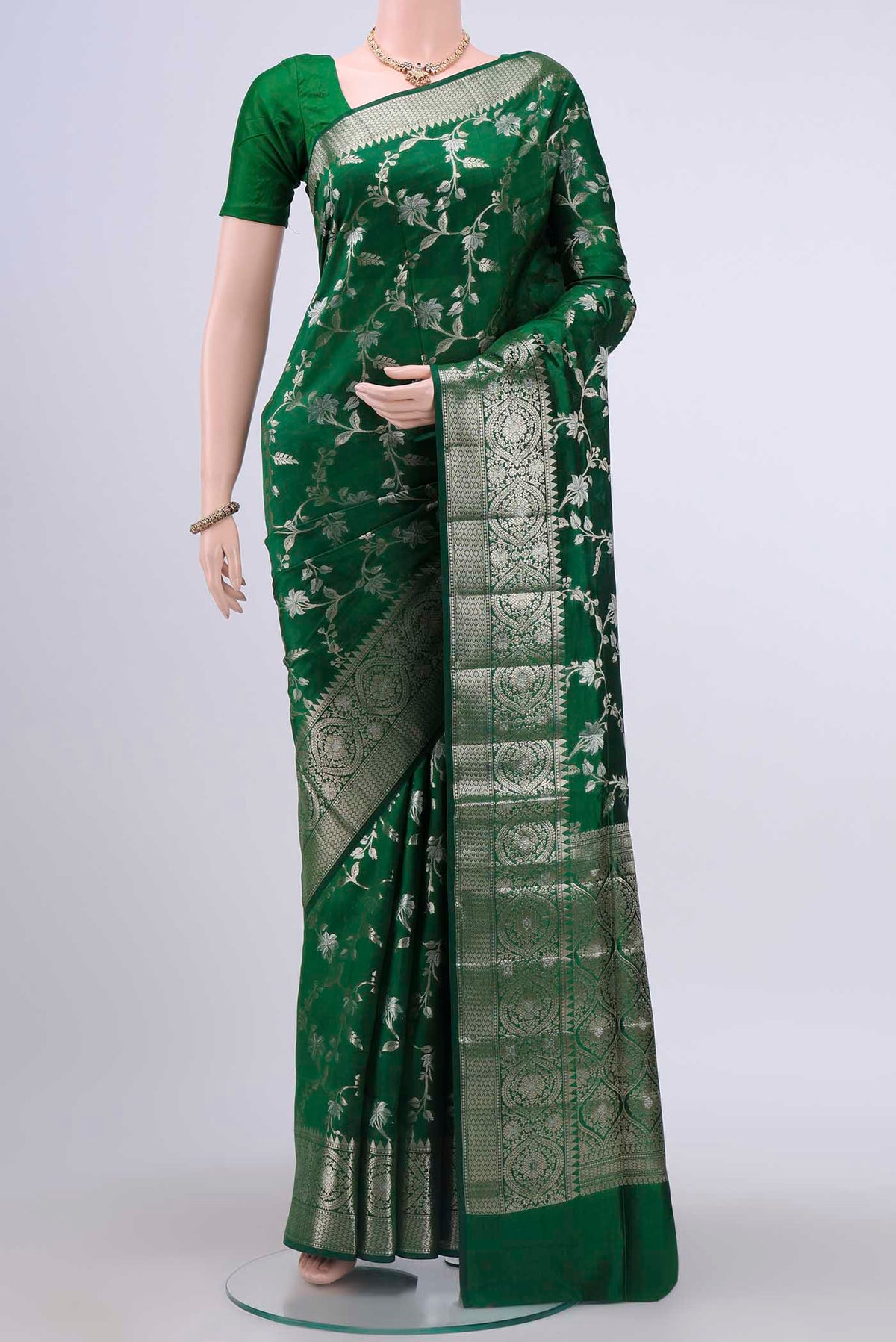Bottle Green Banarasi Raw Silk Saree with Zari Butta on the body and Zari Border displayed on a mannequin