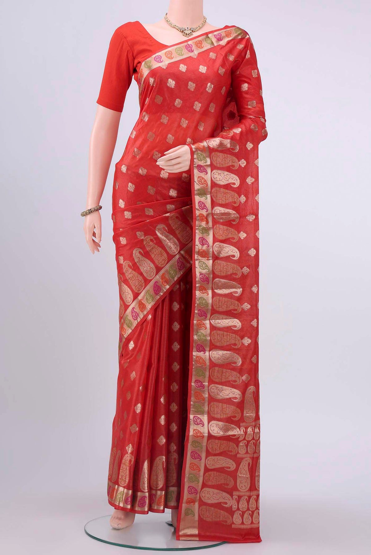 Red Banarasi Tussar Silk Saree with Zari Butta on the body and Zari And Thread Border displayed on a mannequin