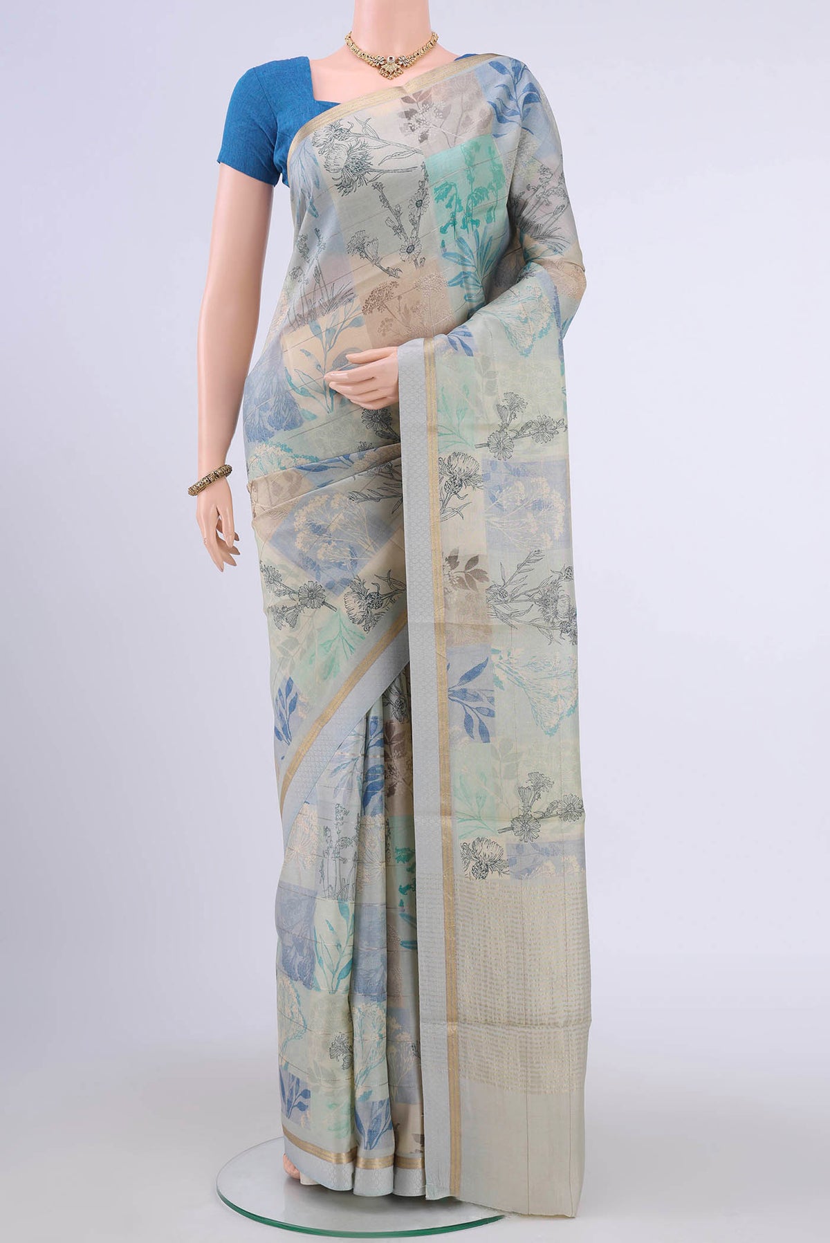 Multi Color Tussar Silk Saree with Floral Print on the body and Zari Border displayed on a mannequin