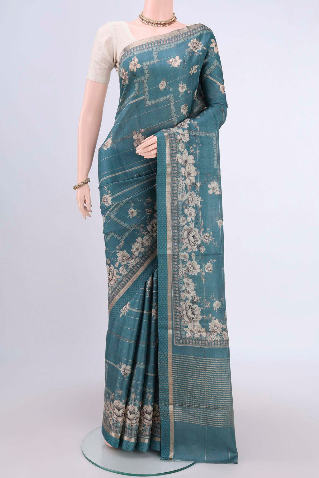Maya Blue Dual Tone Tussar Silk Saree with Printed design on the body and Zari And Thread Border.  displayed on a mannequin