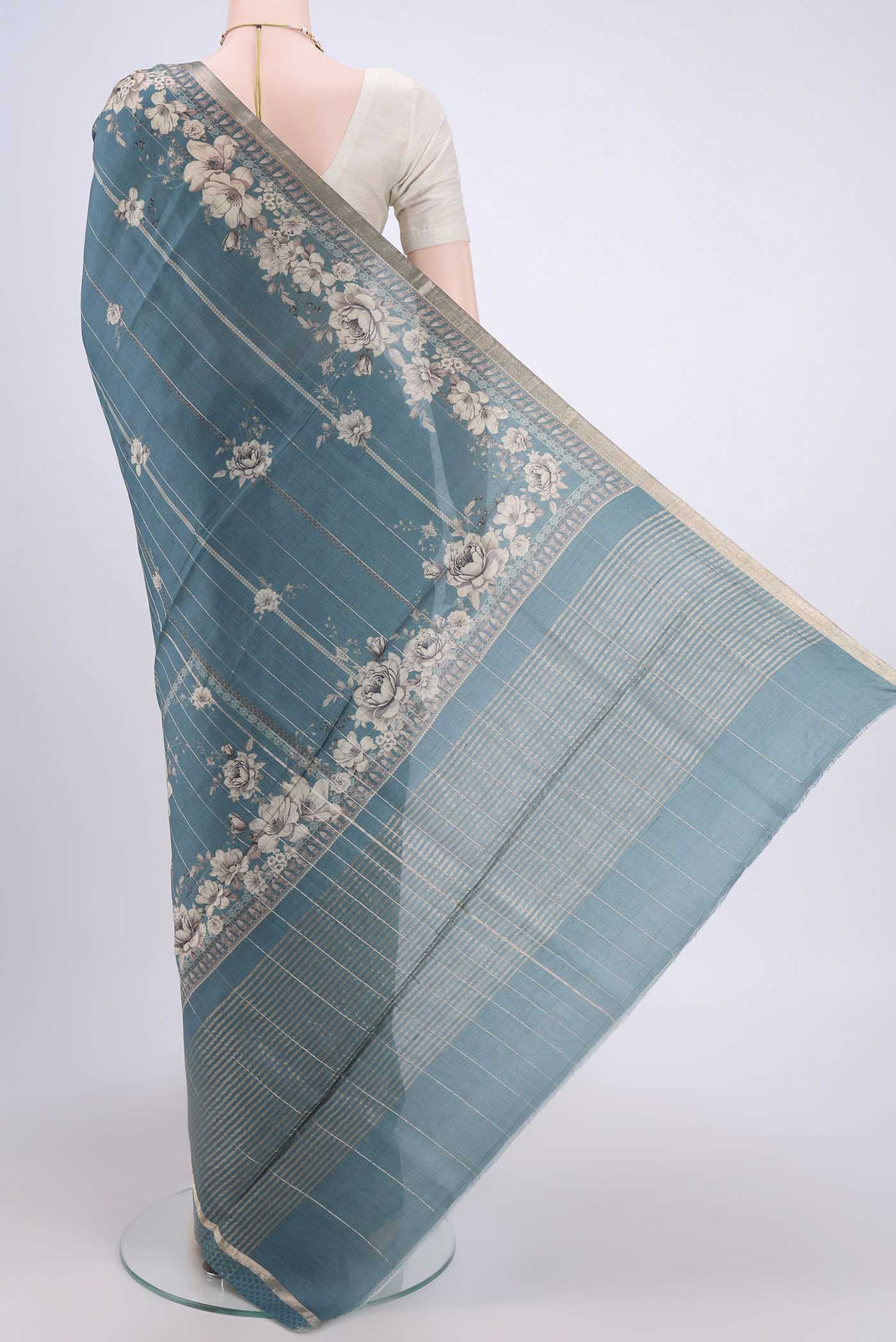 Flat view of Maya Blue Dual Tone Tussar Silk Saree with Printed design on the body and Zari And Thread Border. 