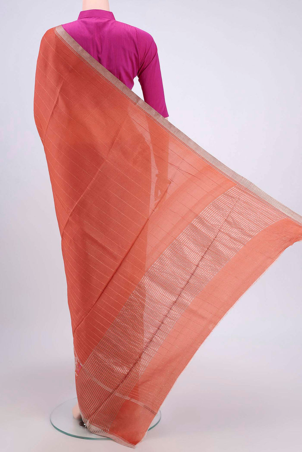 Flat view of Rust Tussar Silk Saree with Printed design on the body and Zari Border. 