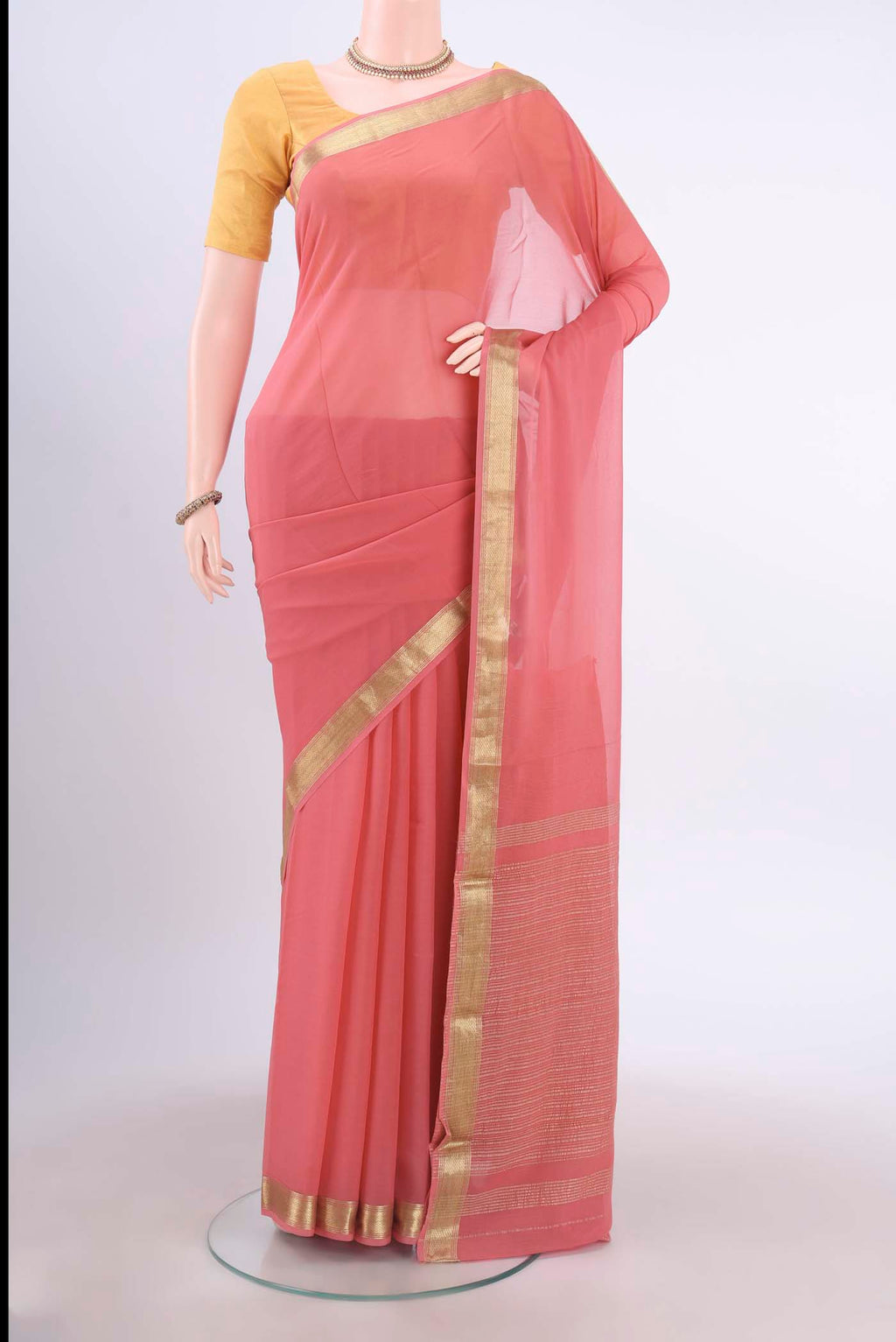 Peach Mysore Georgette Saree with Plain Body and Zari Border displayed on a mannequin