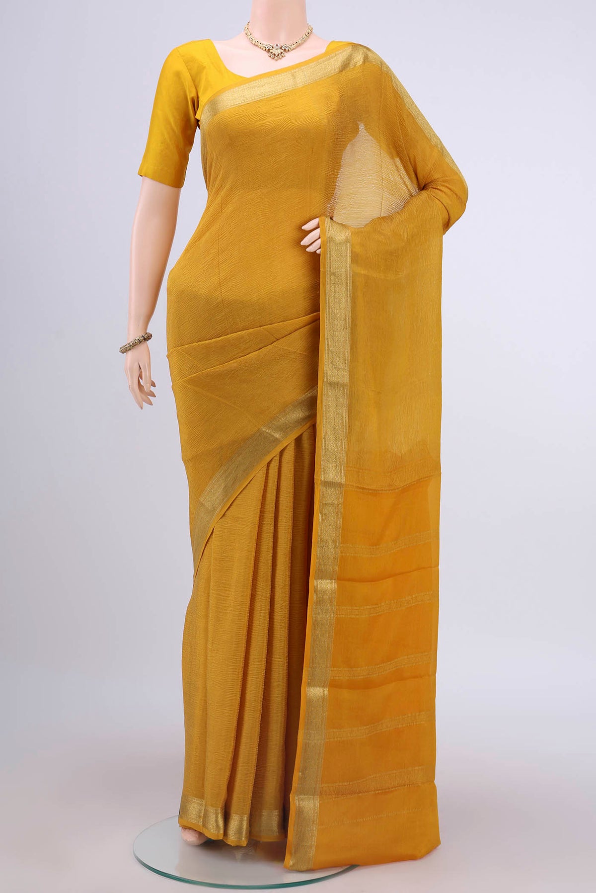 Mustard Mysore Chiffon Saree with Plain Body and Zari Border displayed on a mannequin