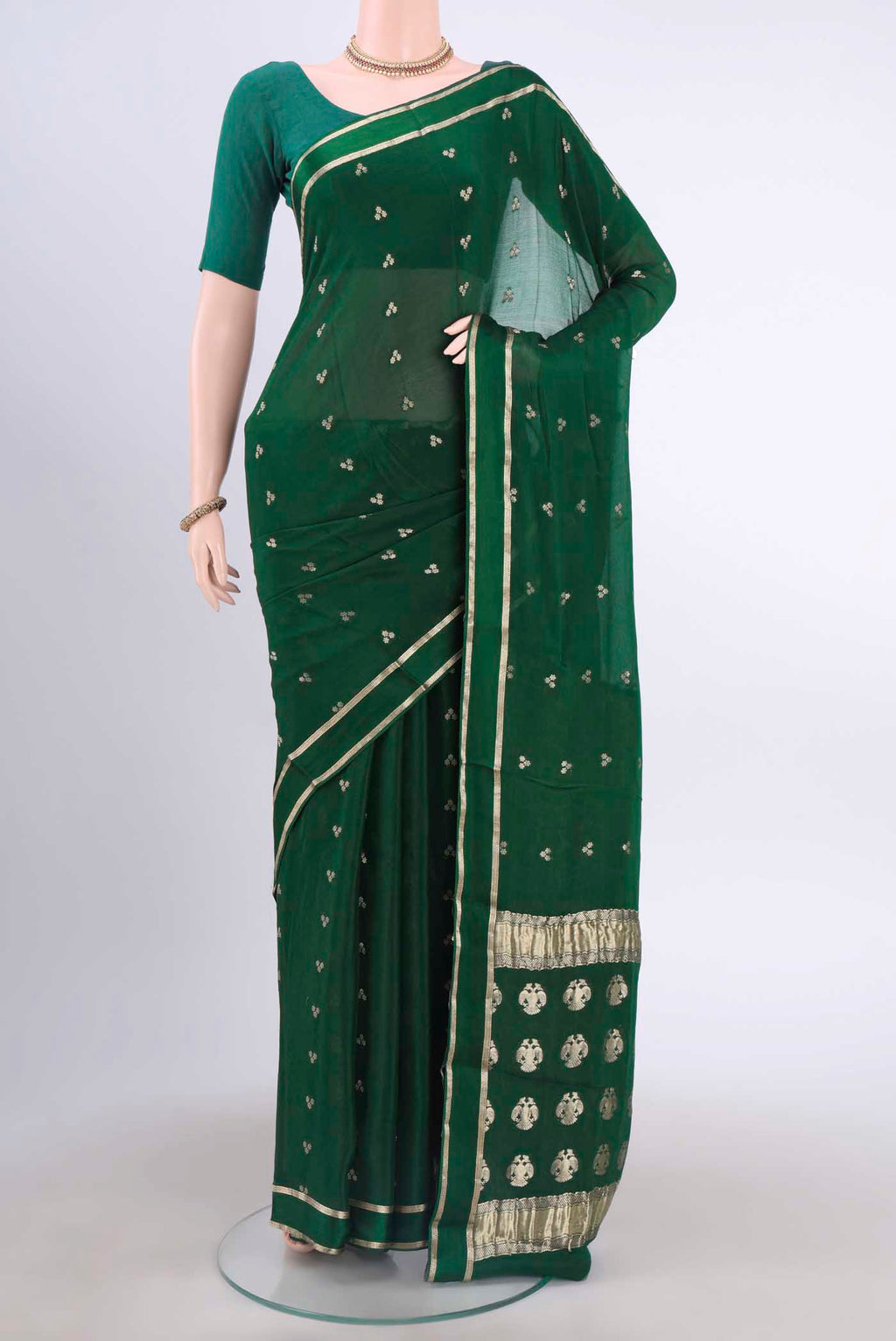 Bottle Green Mysore Crepe Saree with Zari Butta on the body and Satin Border displayed on a mannequin