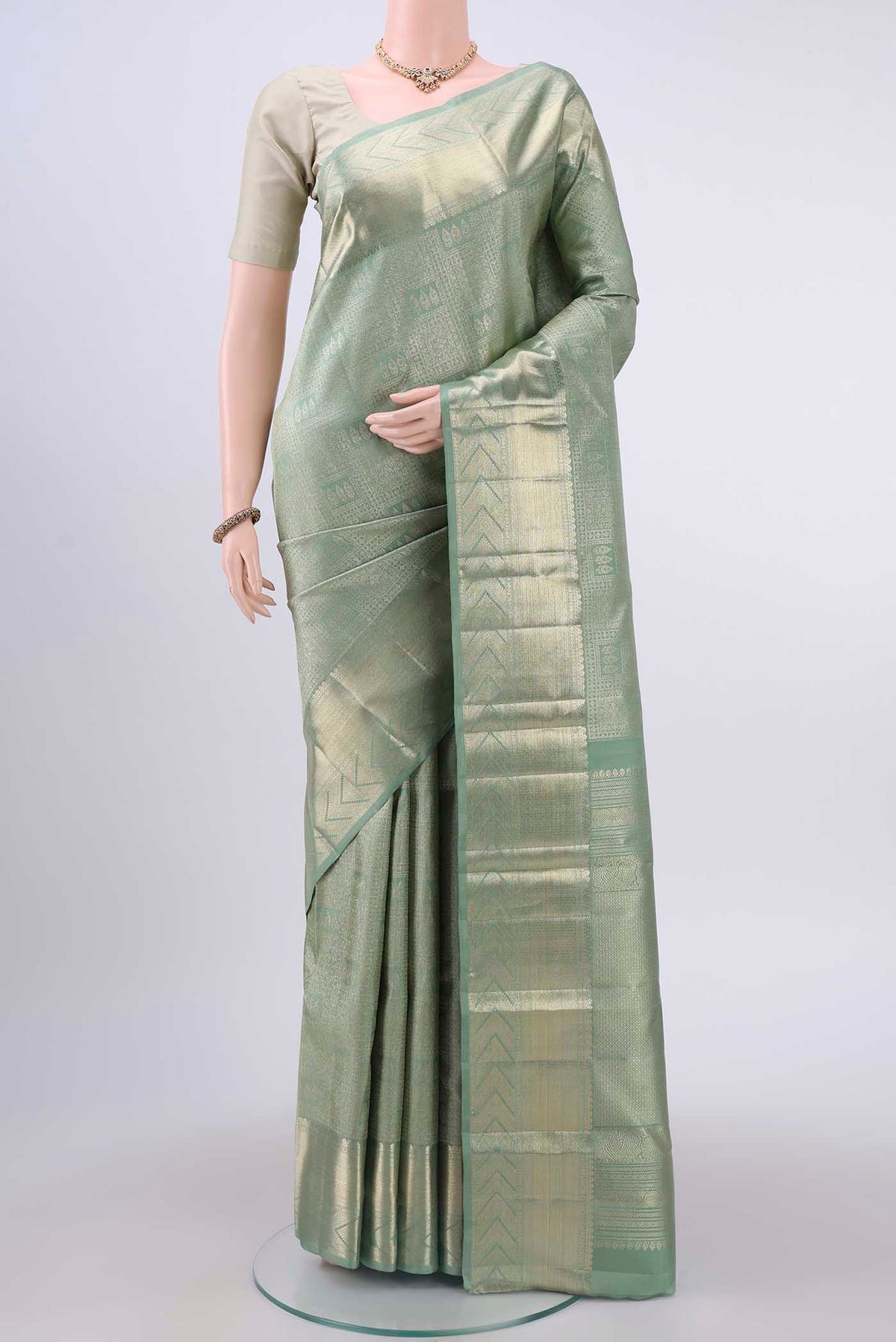 Grey Kanchipuram Silk Saree with Zari Brocade on the body and Zari Border displayed on a mannequin