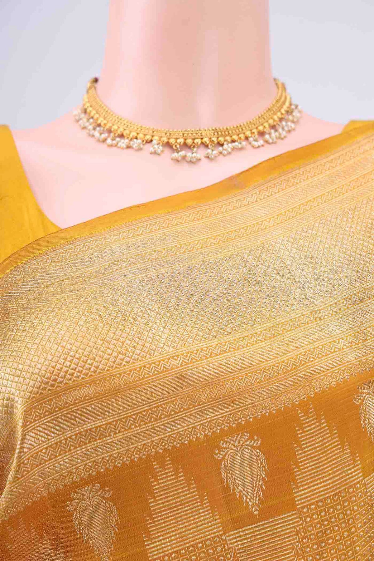 Border image of Mustard Kanchipuram Silk Saree with Zari Brocade on the body and Zari Border