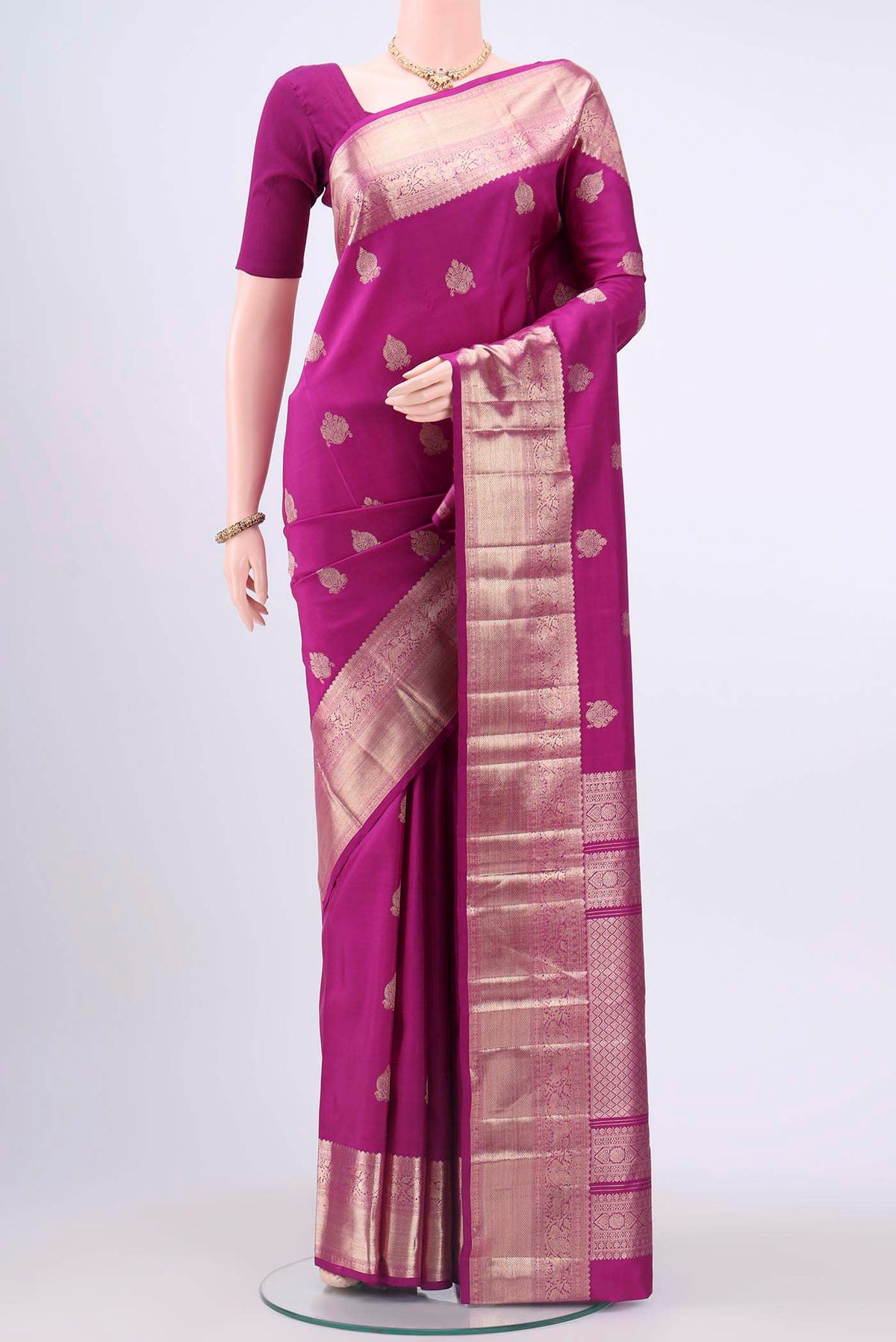 Magenta Kanchipuram Silk Saree with Zari Butta on the body and Zari Border displayed on a mannequin