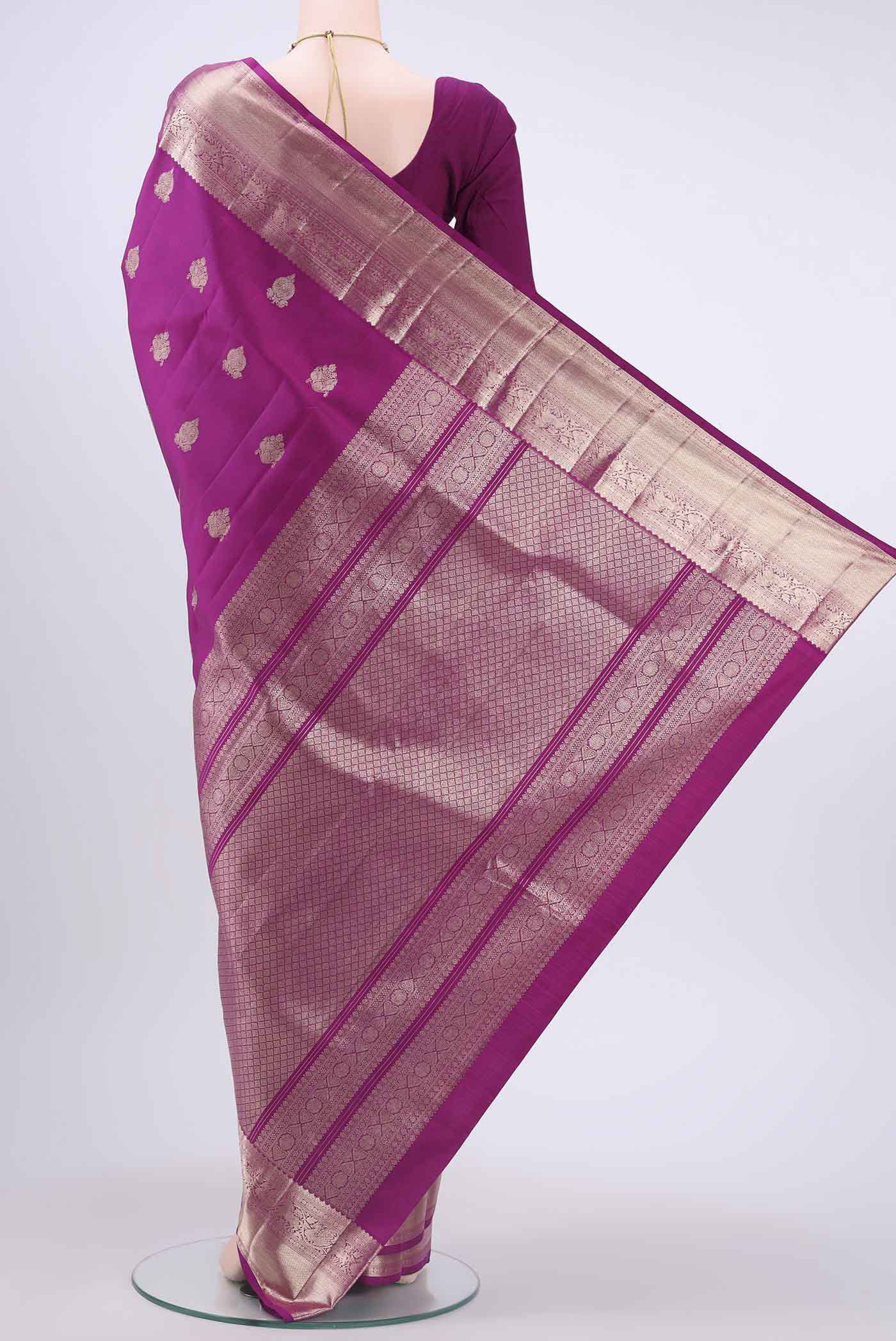 Flat view of Magenta Kanchipuram Silk Saree with Zari Butta on the body and Zari Border