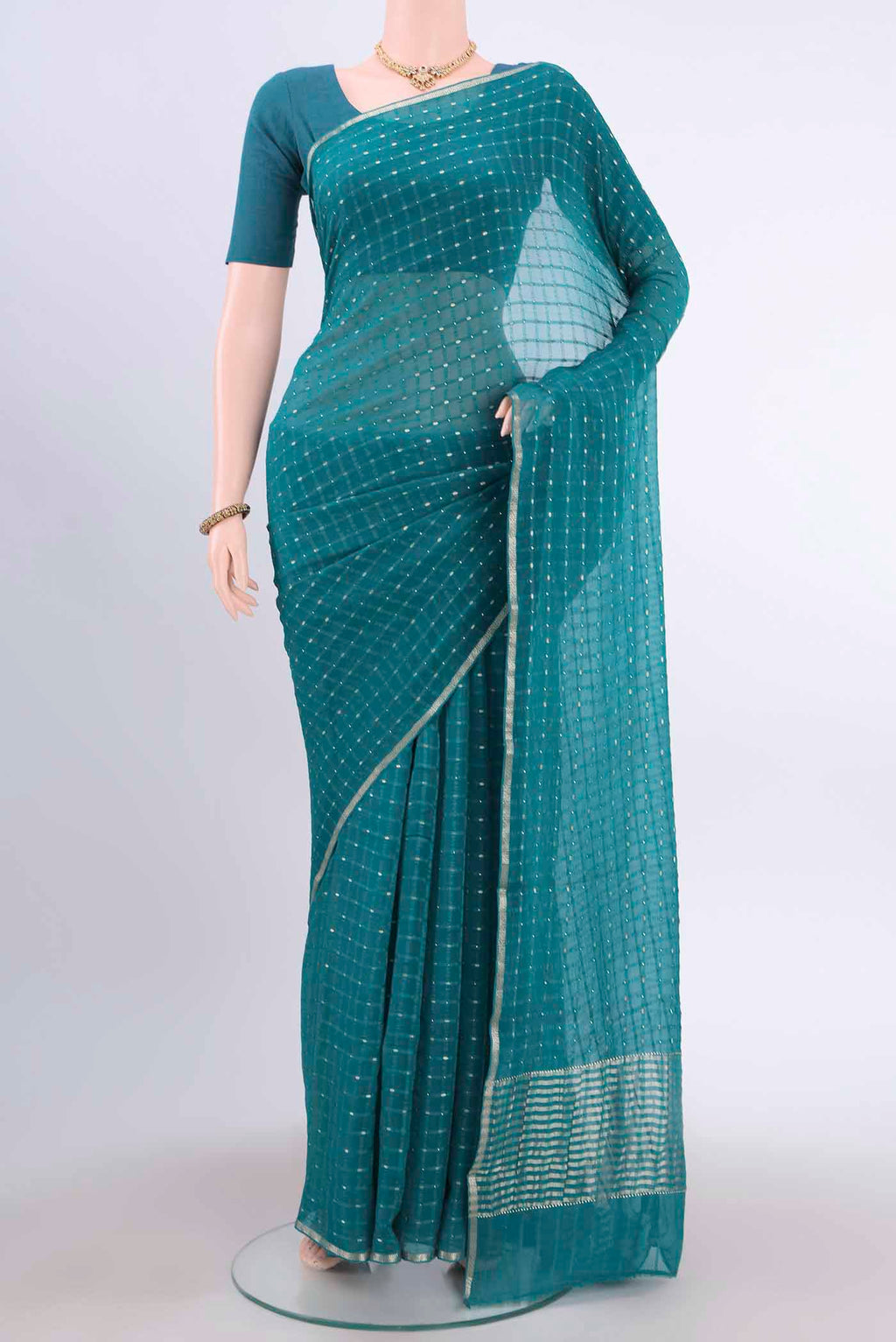 Turquoise Mysore Chiffon Saree with Checked design on the body and Thin Zari Line displayed on a mannequin