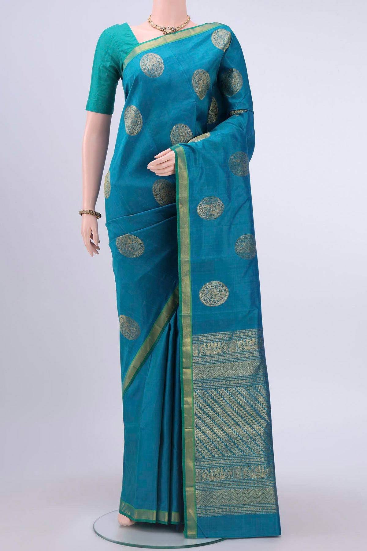 Blue Kanchipuram Silk Saree with Zari Butta on the body and Zari Border displayed on a mannequin
